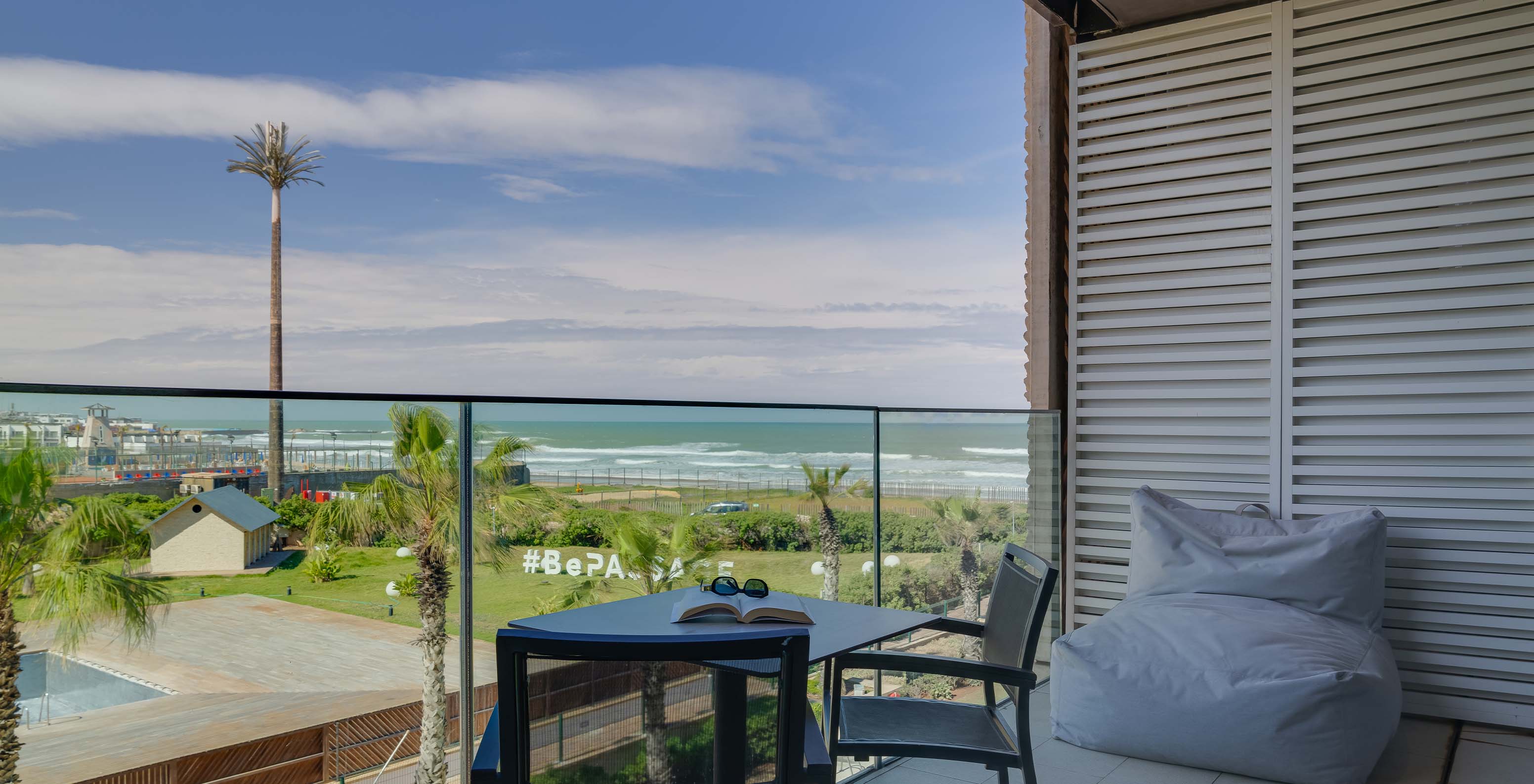 Pestana Casablanca, 4-Star Hotel in Casablanca, Morocco featuring a balcony overlooking palm trees and ocean