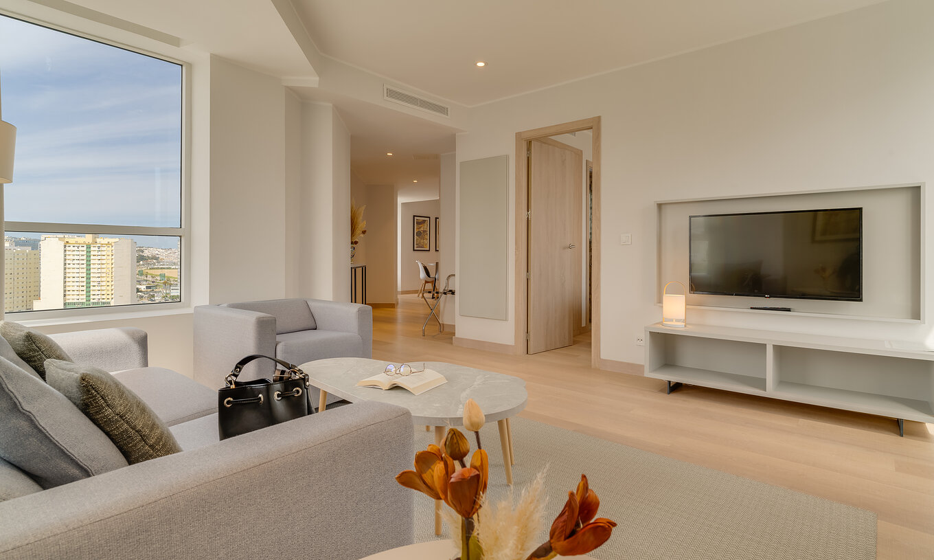 The Premium Suite of Pestana Tanger City Center features a living room with sofa, television, and an armchair