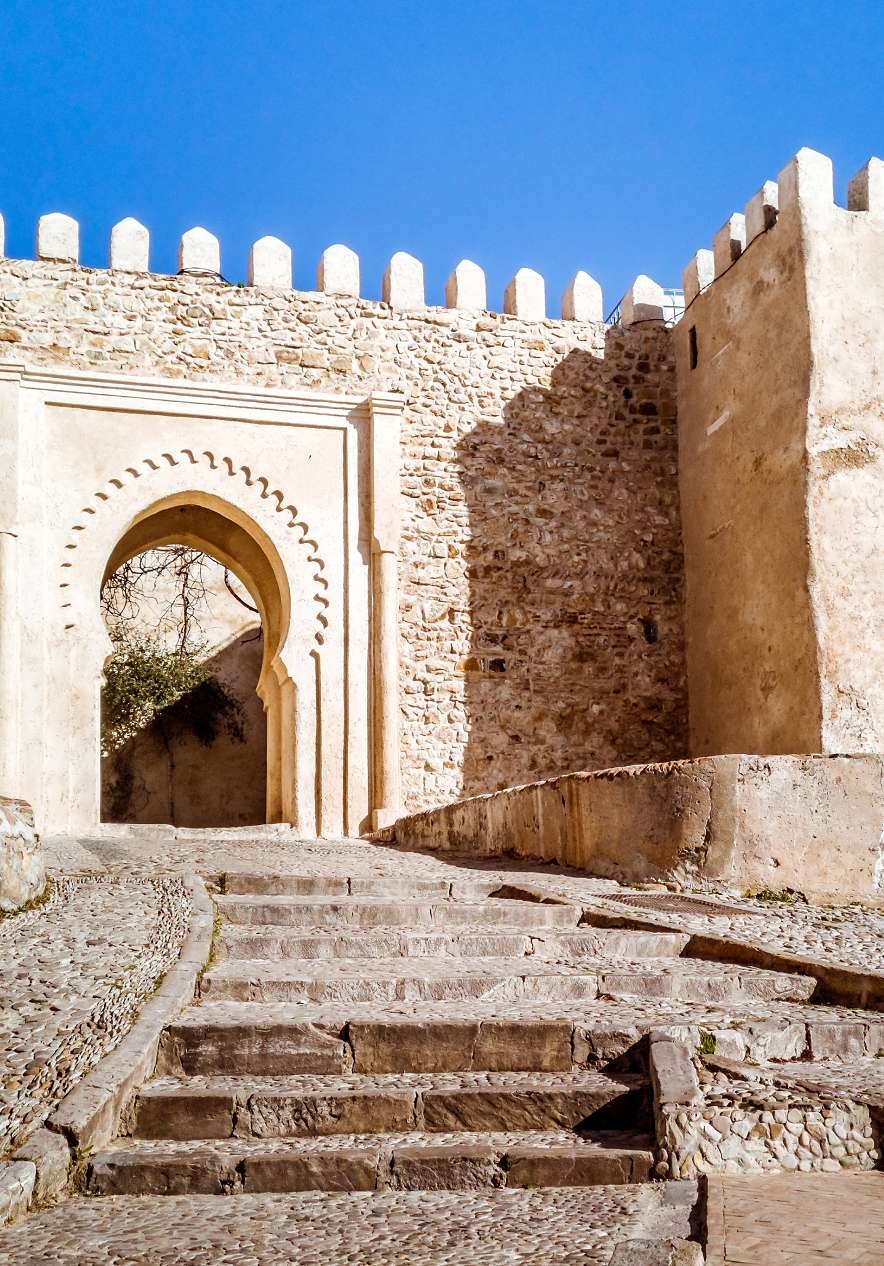Kasbah stone gate near Pestana Tanger City Center, Hotel em Tânger Perto da Praia with sunlit walls and arch