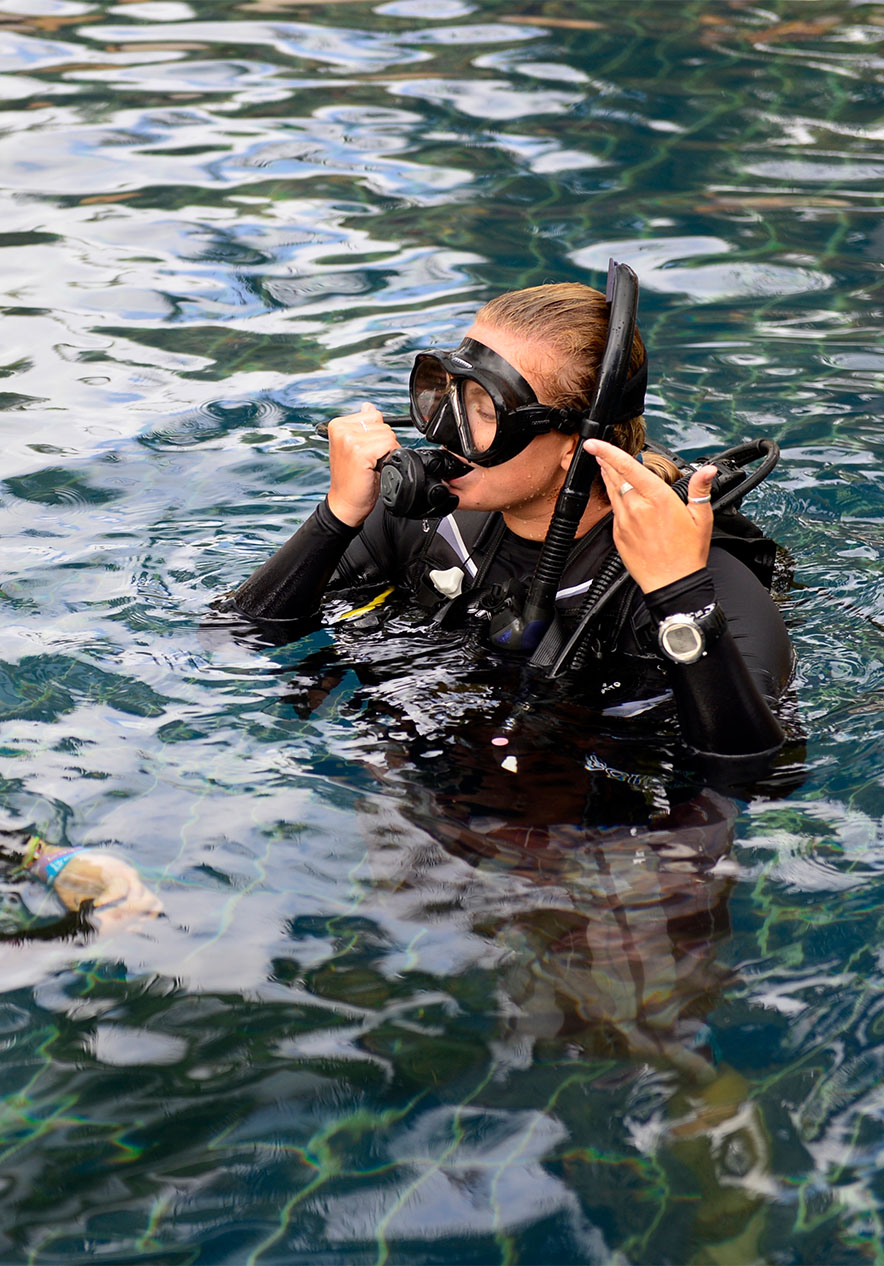 Scuba diving near Pestana Bazaruto Lodge, Eco Resort na Ilha de Bazaruto with diver adjusting mask in clear water