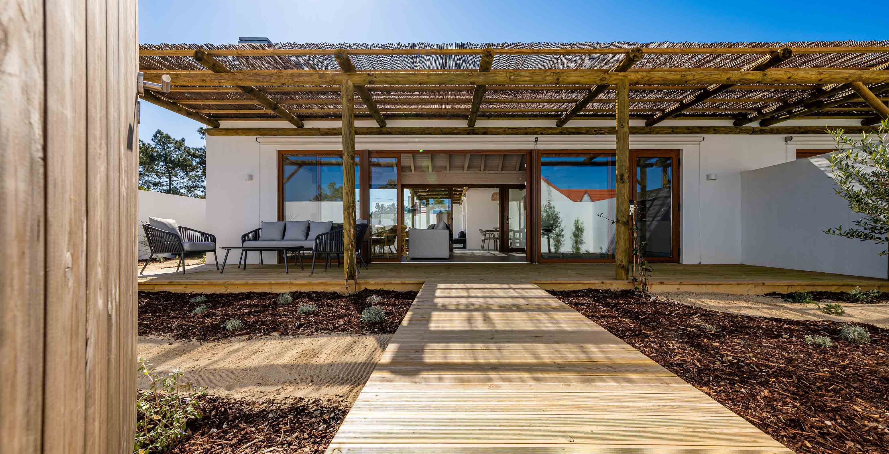 The Premium Villa at Pestana Comporta Village Residences has an entrance with a wooden deck, a pergola, and a garden