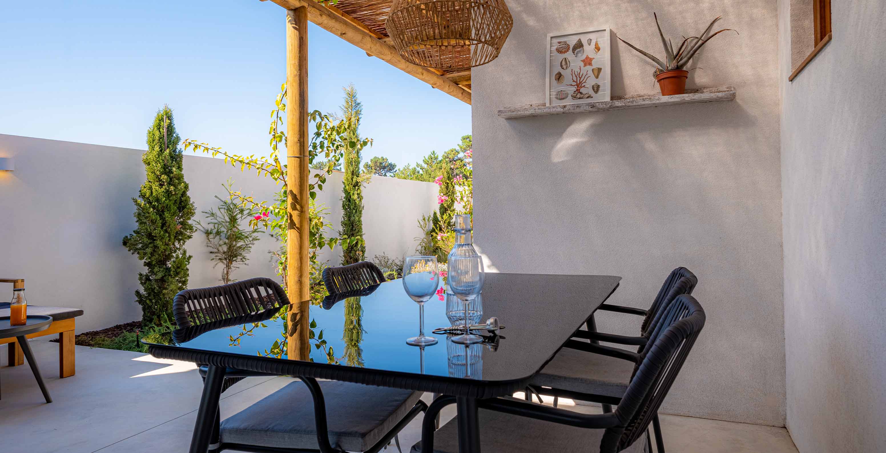 The Standard Villa T1 at Pestana Comporta Village Residences has an outdoor dining table under a pergola
