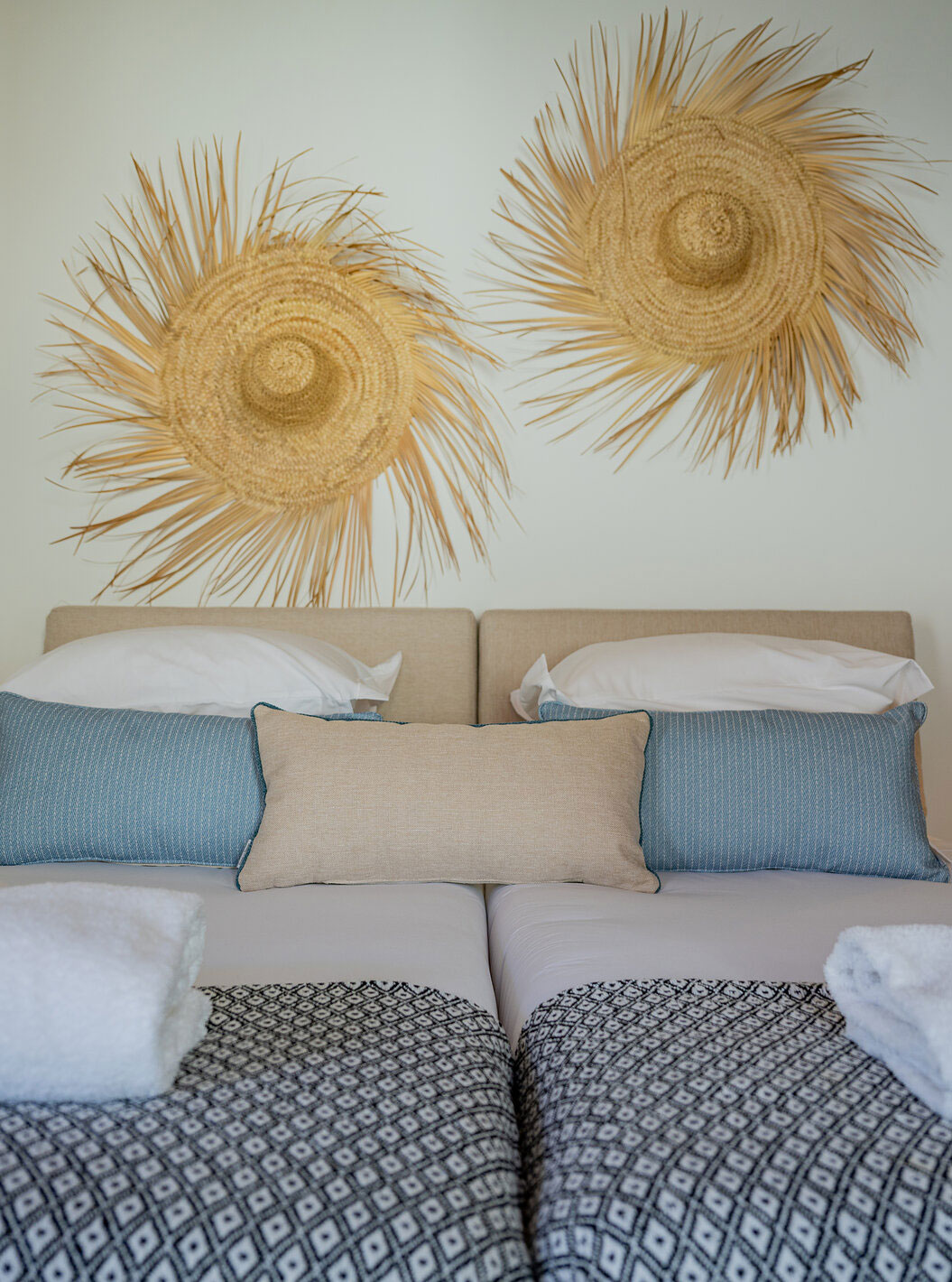 The Standard Villa at Pestana Comporta Village Residences has a double bed with straw decoration on the wall