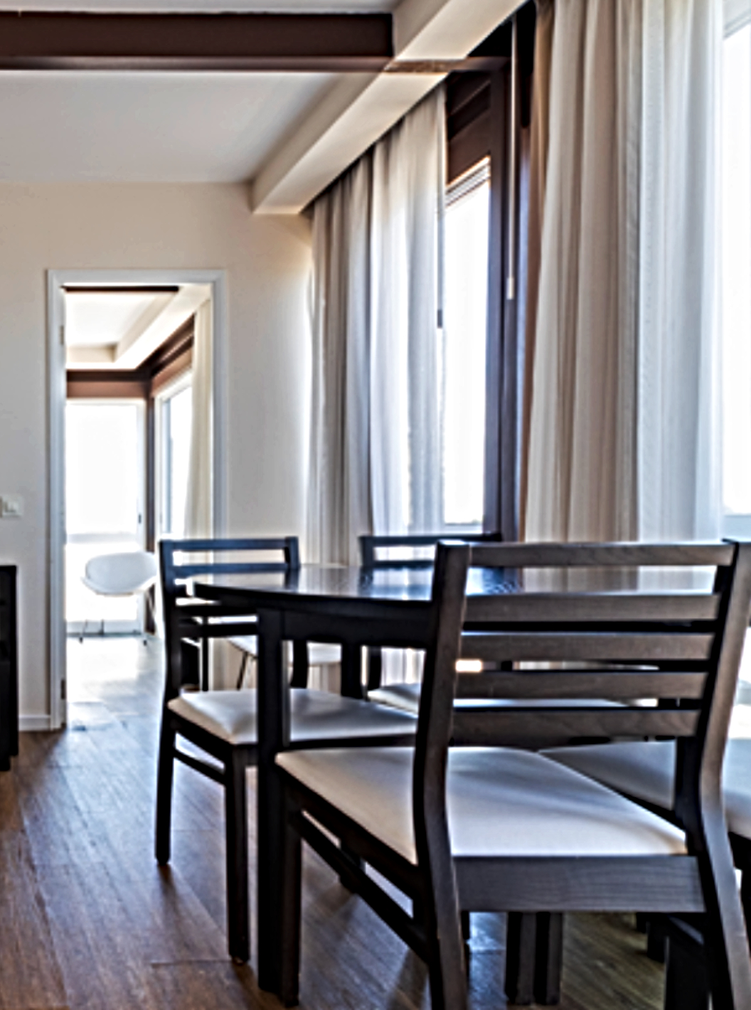 The Superior Sea View Studio at Pestana Alvor Atlântico features a bright living area with a sofa, dining table, and television, offering a cozy atmosphere with large windows that let in plenty of natural light.