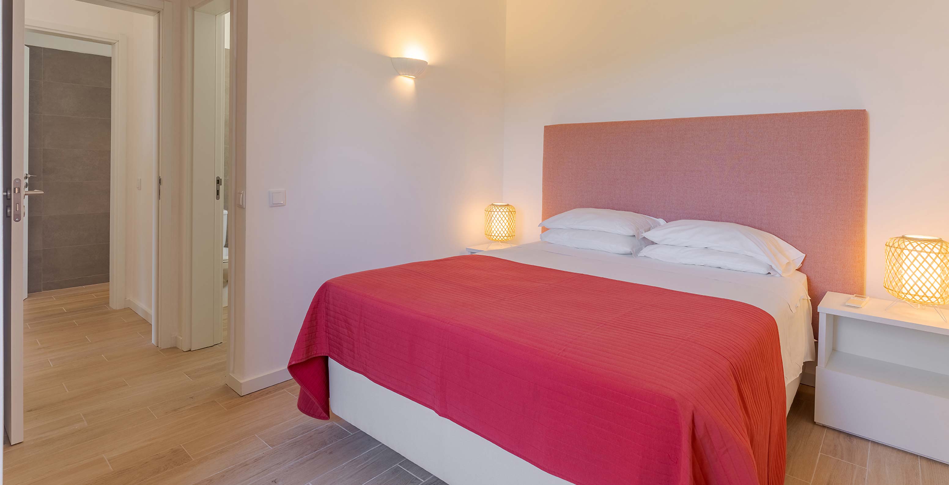 The Superior 2-Bedroom Garden View Villa at Pestana Alvor Beach Villas has a double bed with a red bedspread