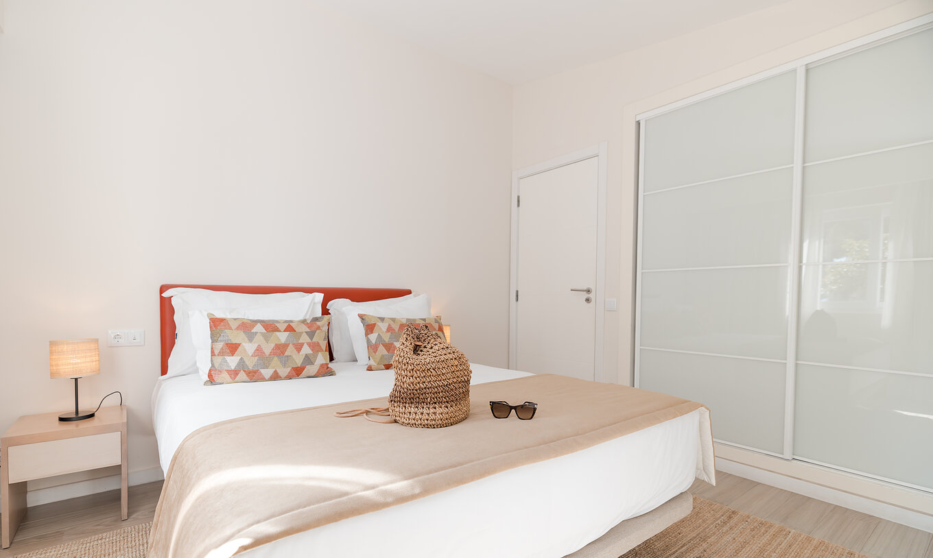 Villa 2 Bedrooms Premium at Pestana Alvor Beach Villas has a bedroom with double bed and built-in wardrobe