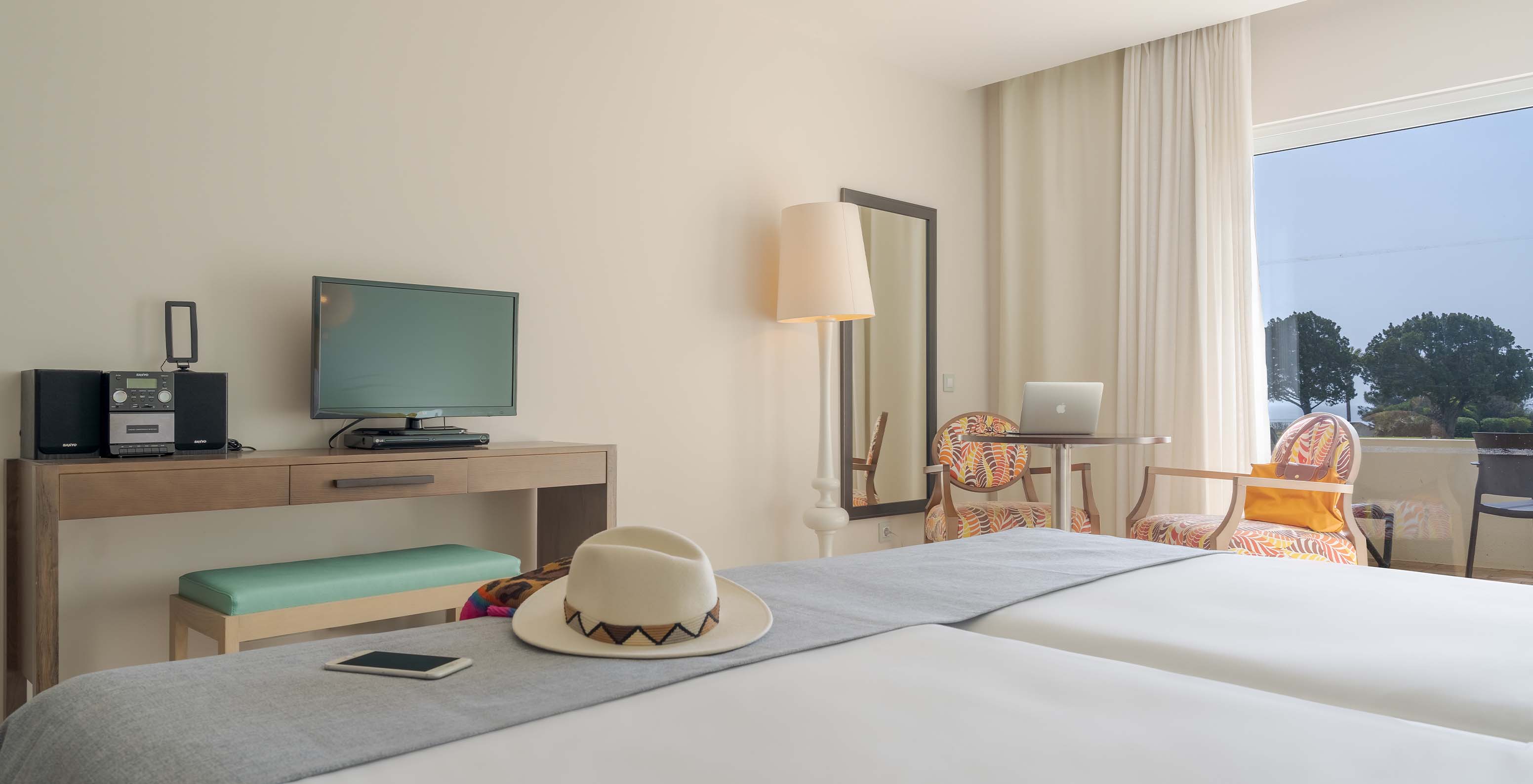 The Sea View Studio at Pestana Alvor Praia has a desk with a TV, a wall mirror, and a window to the balcony