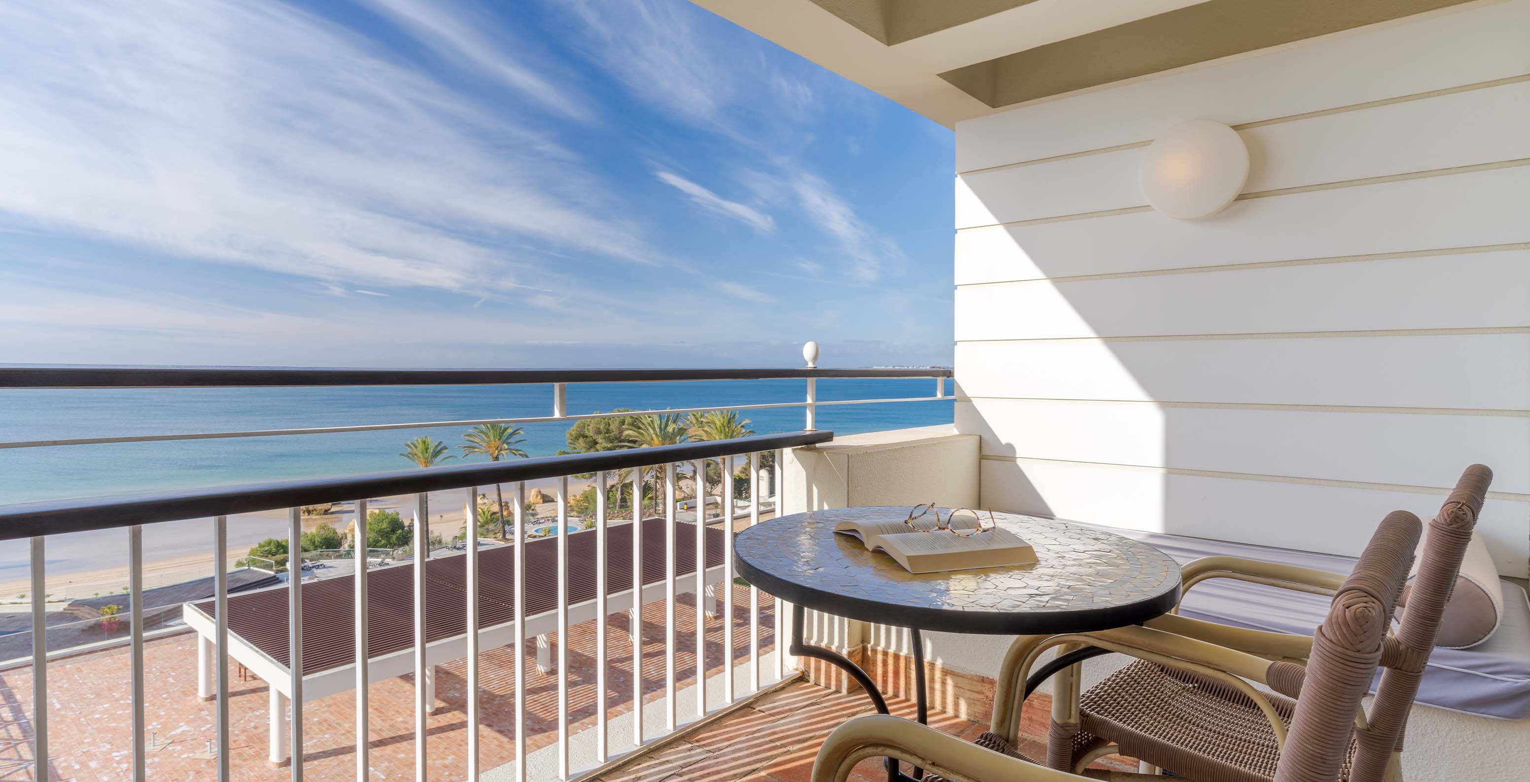 The Superior Sea View at Pestana Alvor Praia has a balcony with a table, chairs, and a sofa with sea views