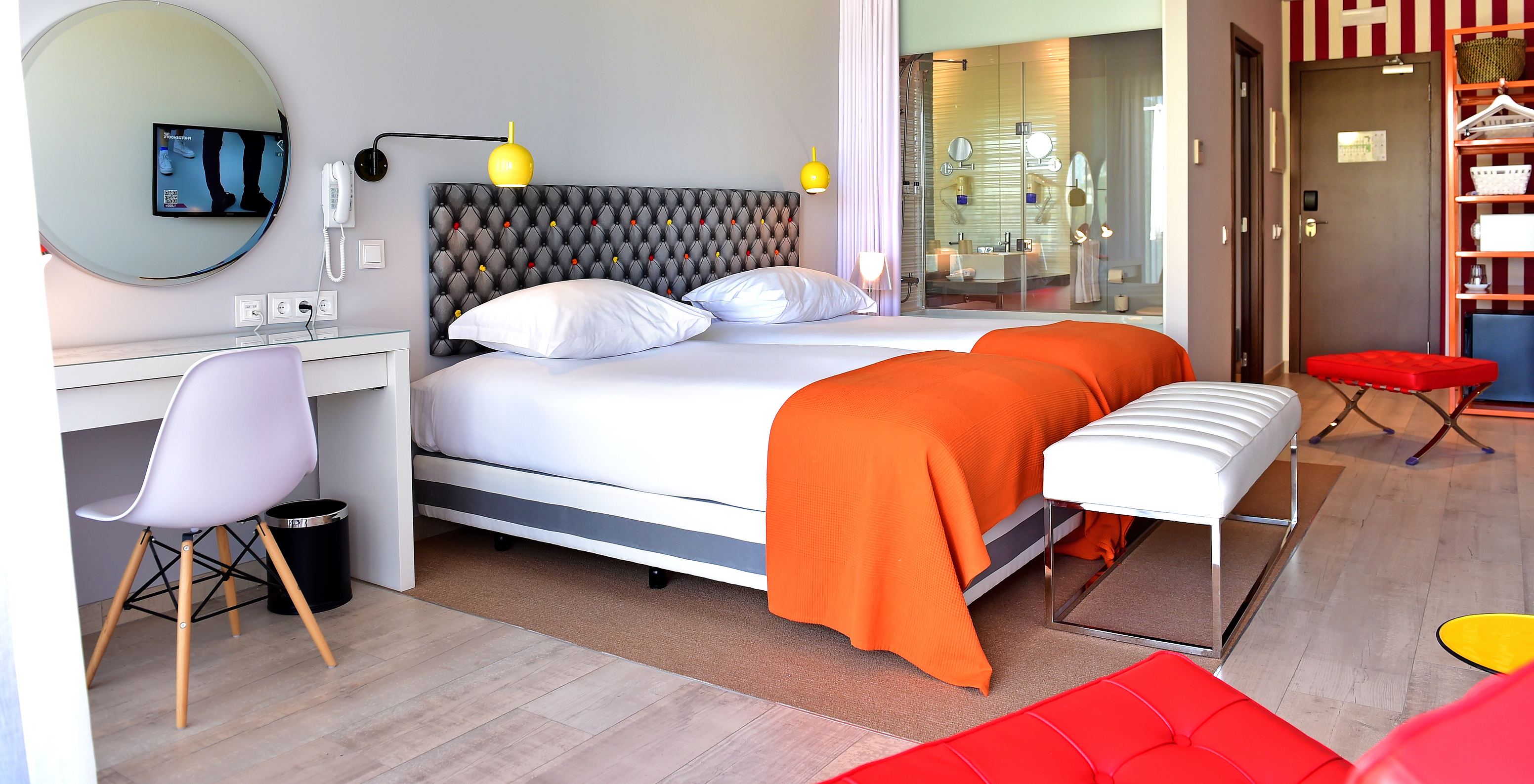 The Deluxe Pool View of Pestana Alvor South Beach has two single beds together and a stool at the foot of the bed