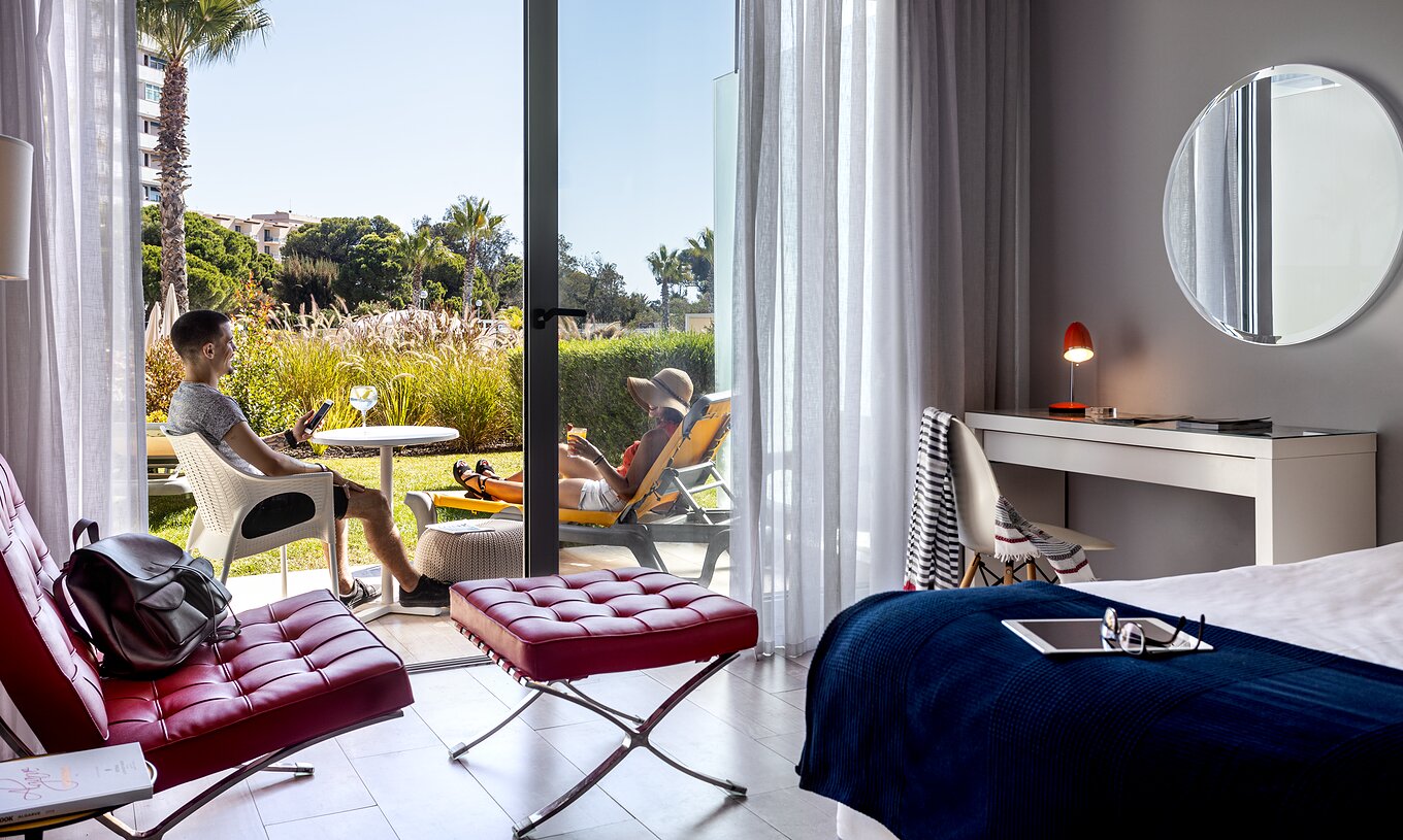 The Deluxe Pool View of Pestana Alvor South Beach has a terrace with chairs in the garden overlooking the pool