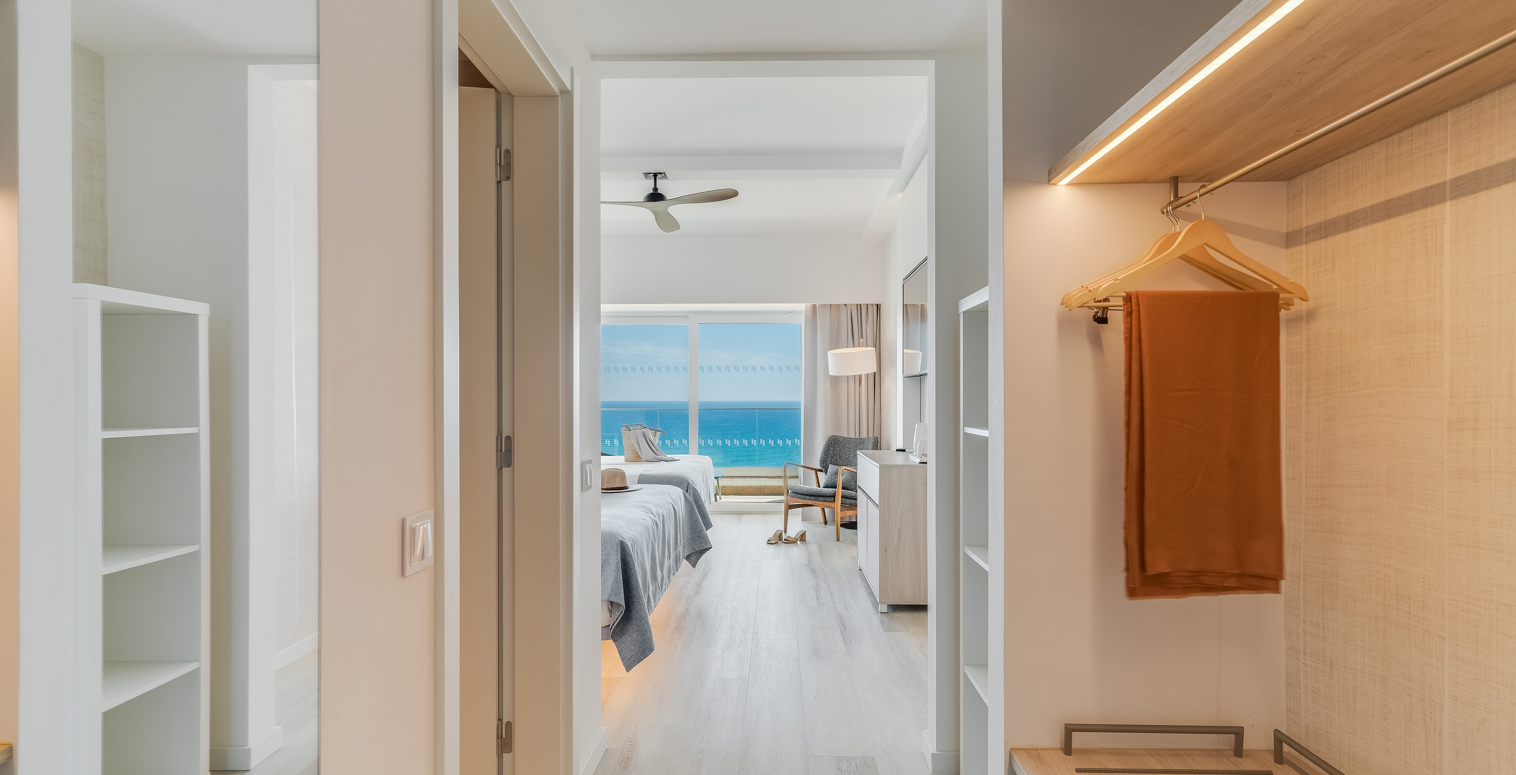 The Superior Family Sea View Room at Pestana Blue Alvor Beach has a hallway with a wardrobe and mirror, and a balcony