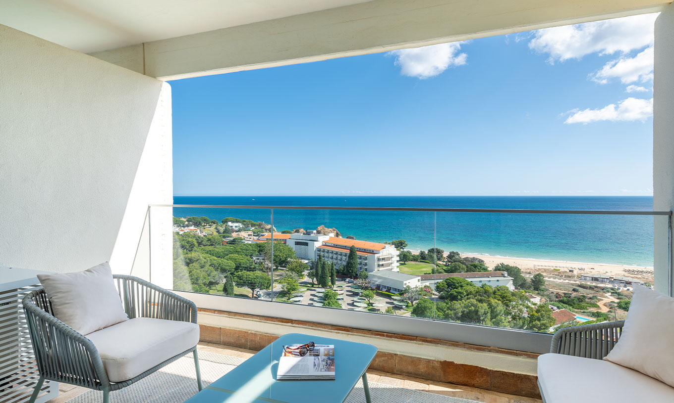 The Superior Family Sea View Room at Pestana Blue Alvor Beach has a balcony with a table and two chairs, and a sea view