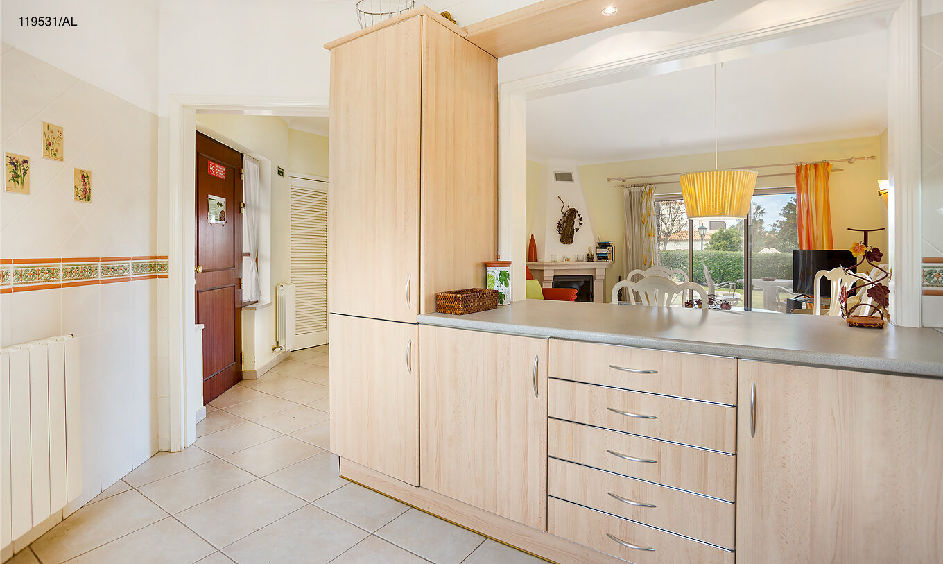 The Pestana Carvoeiro Golf T1 Standard Apartment has an entry to a kitchen with wooden cabinets