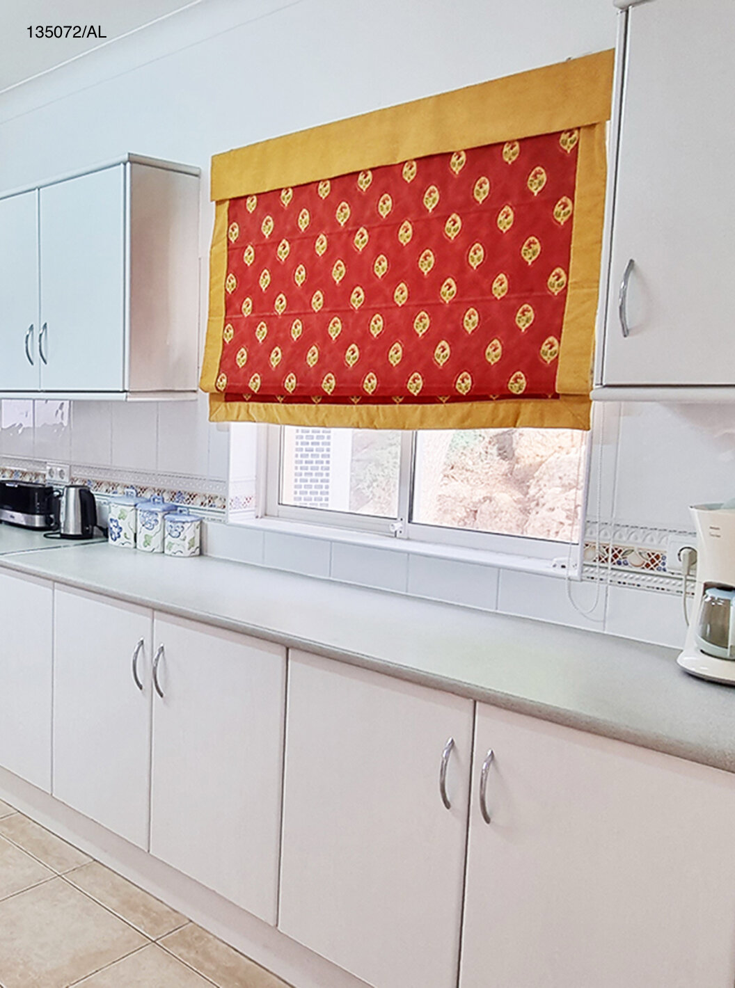 The Pestana Carvoeiro Golf V3 Standard Villa has a kitchen equipped with white cabinets and appliances