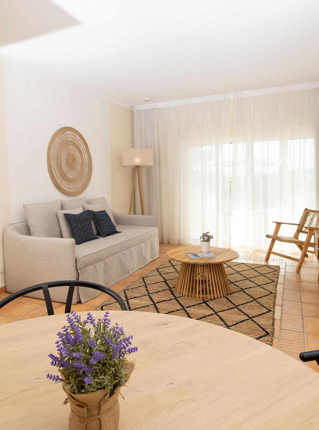 2 Bedroom Superior Apartment at Pestana Palm Gardens featuring a sofa, woven chairs and sunlit living area