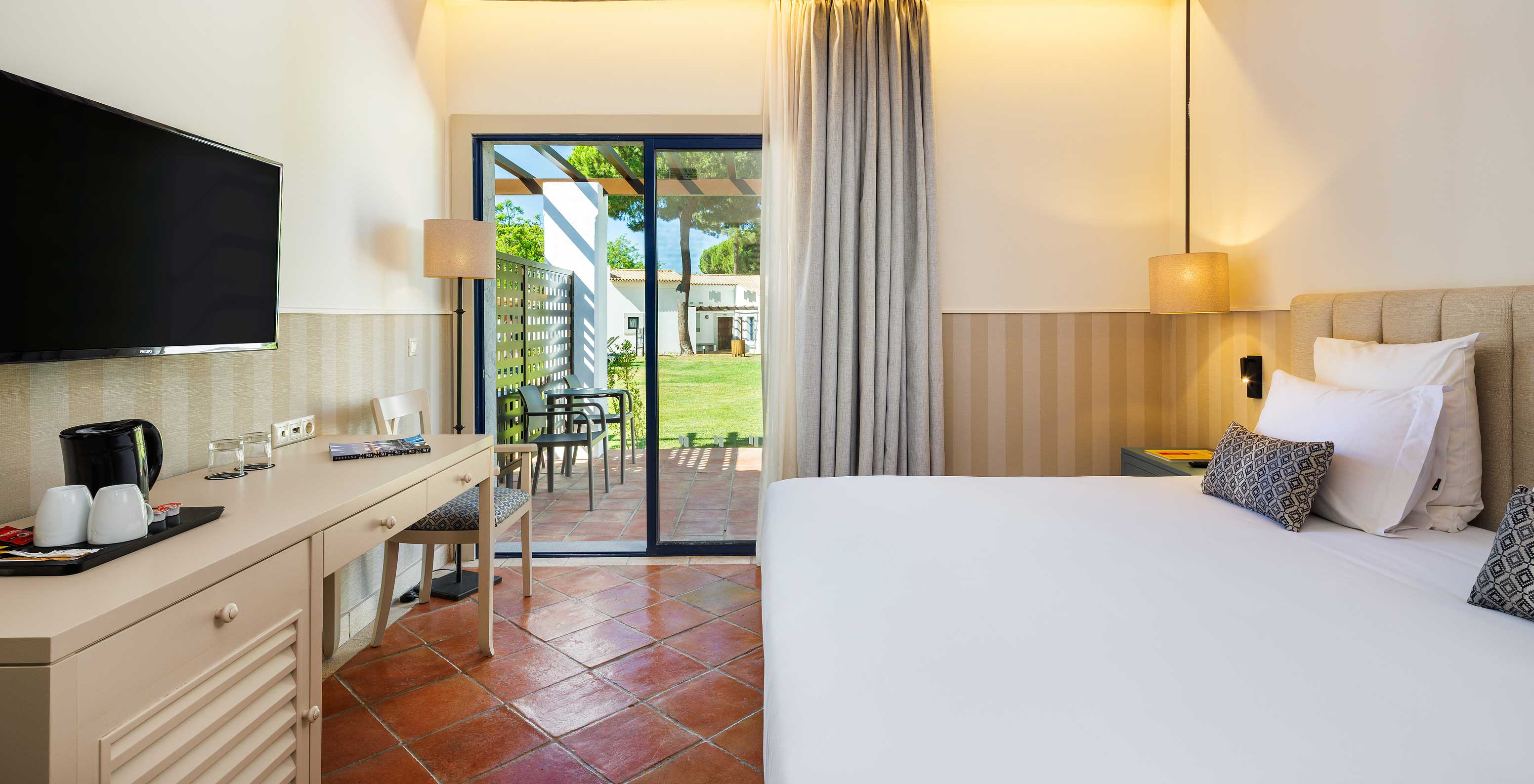 The Superior Garden View at Pestana Vila Sol - Vilamoura has a double bed, TV and window with balcony access