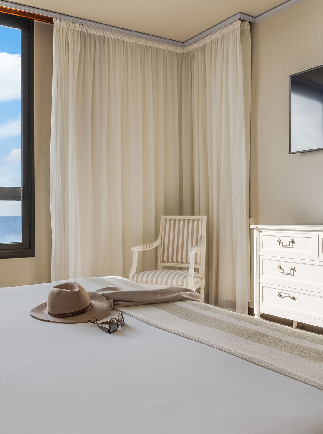 Suite at Pestana Bahia Praia has a double bed, with a window on the left and a TV at the foot of the bed