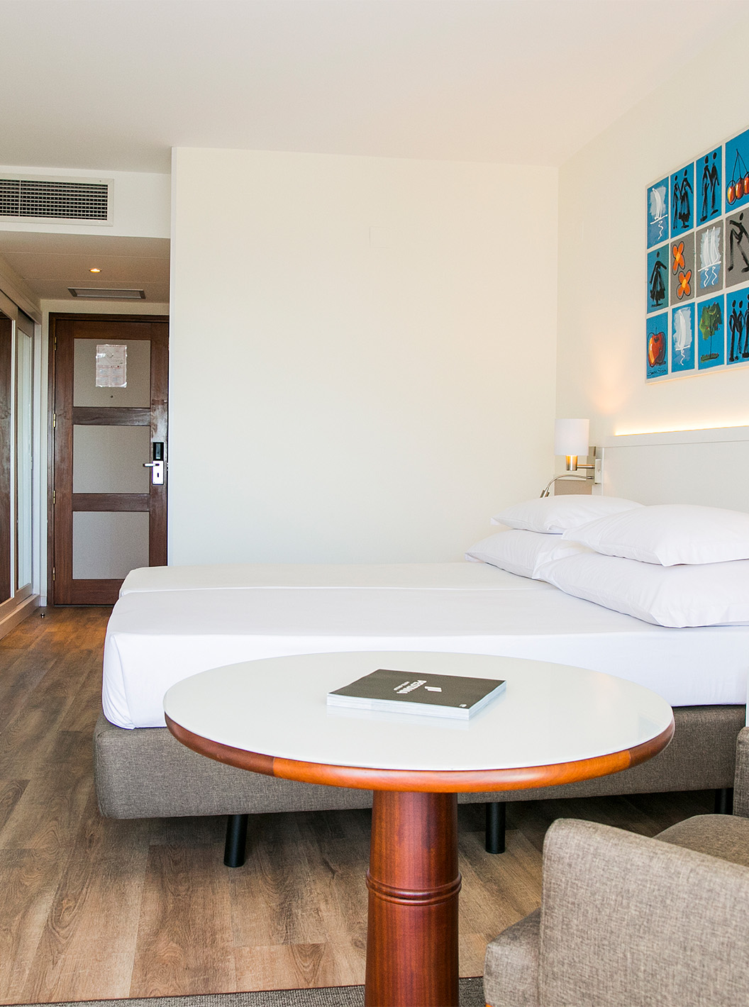 The Superior Deluxe room at Pestana Cascais has two single beds, a TV, a desk, and a kitchen