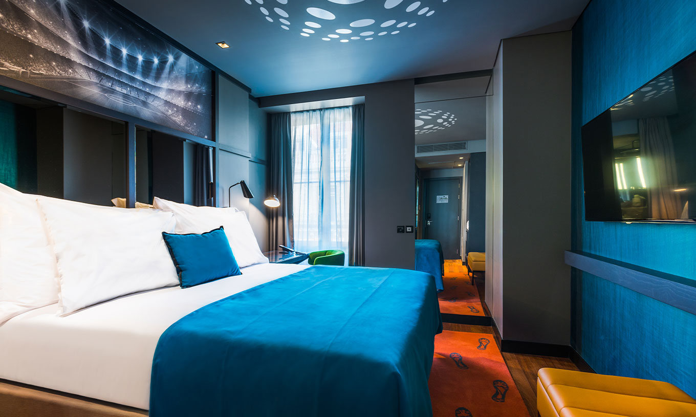 The CR7 Room at Pestana CR7 Lisboa includes a double bed, a mirror, and a desk
