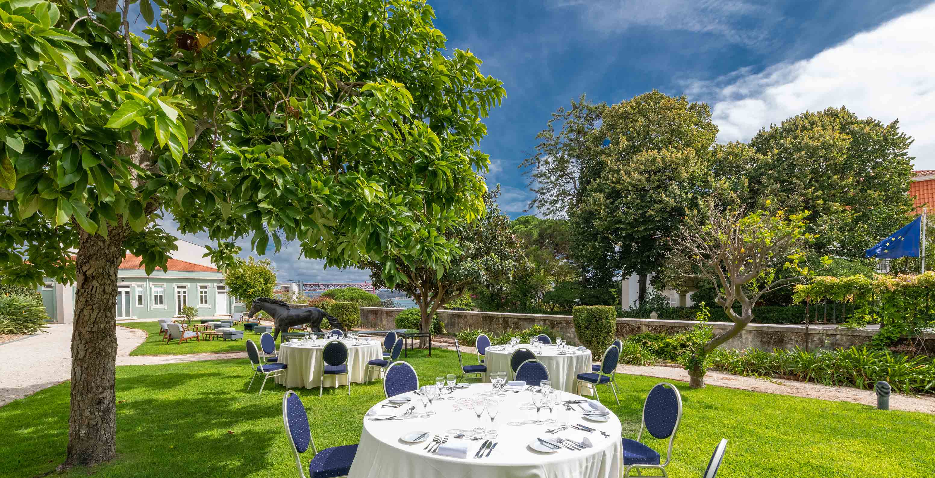 Area of the old stables at Pestana Palace Lisboa prepared for an event with round tables and chairs