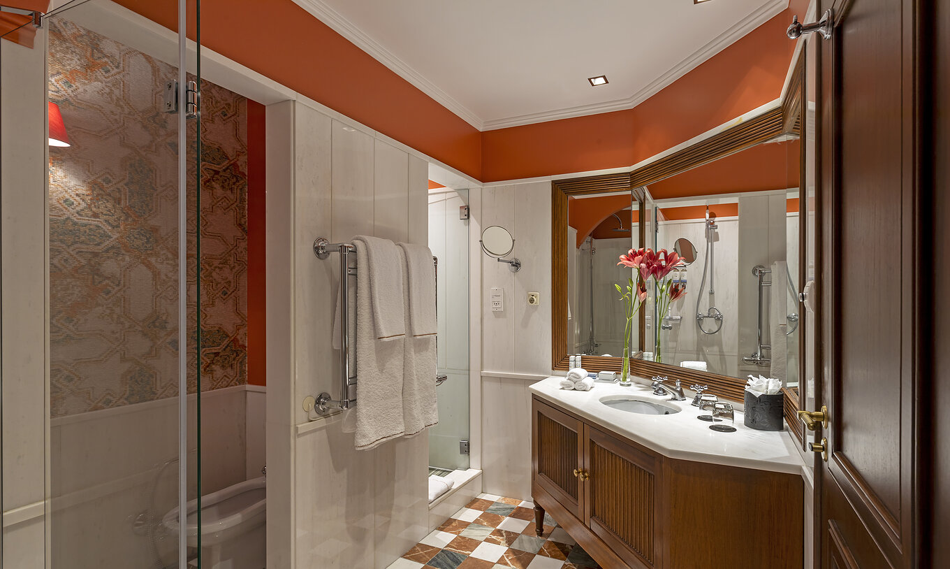 The Suite at Pestana Palace Lisboa has a bathroom with a shower, bathtub, toilet, bidet, and a large sink with a mirror