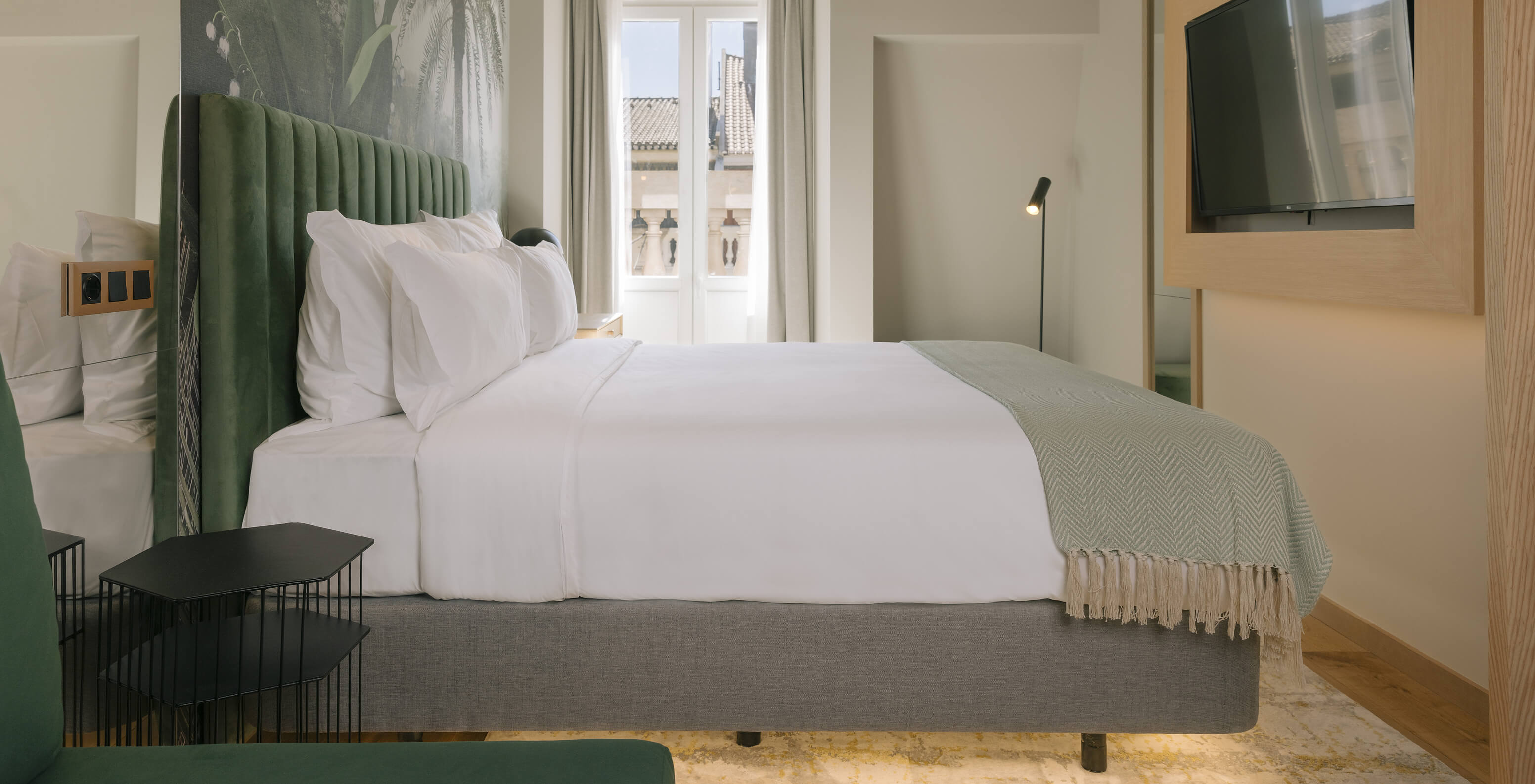 The Superior Plus at Pestana Rua Augusta Lisboa has a double bed, a television, and a window with access to a balcony
