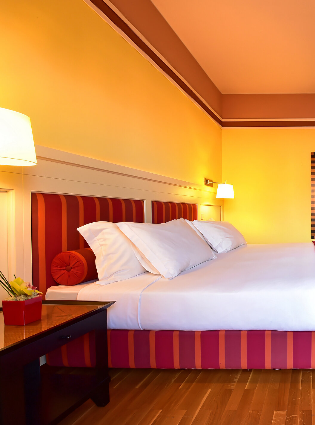 The Superior Suite of Pestana Sintra Golf has a double bed, a mirror on the wall, and a unit with a small television