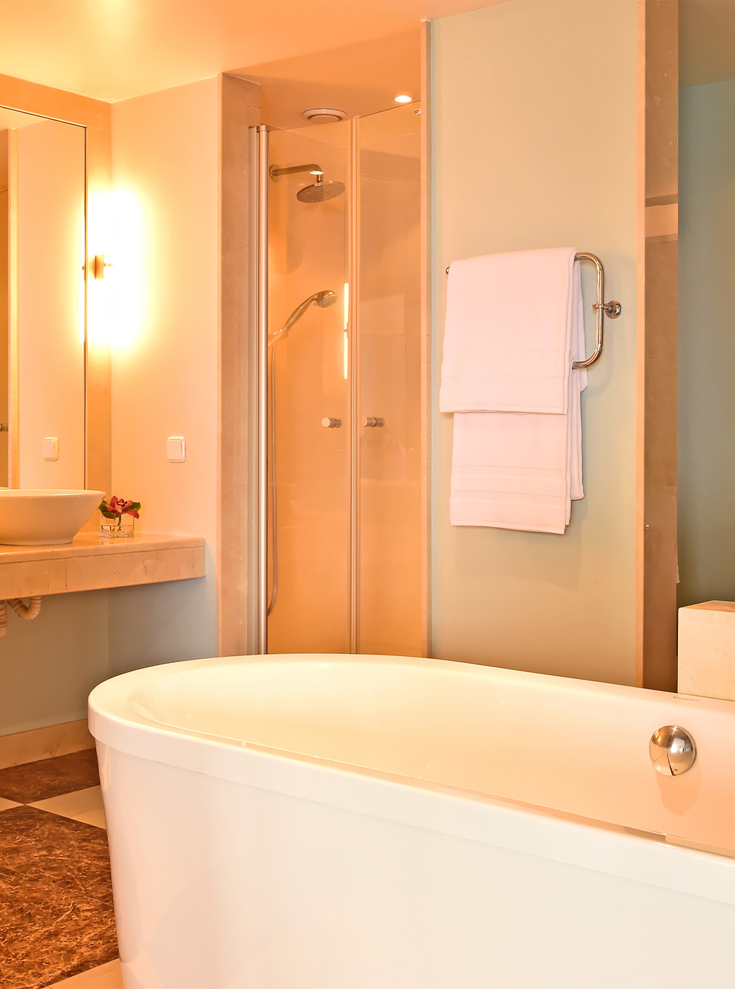 The Superior Junior Suite at Pestana Carlton Madeira has a bathroom with a bathtub, sink, and decorative elements