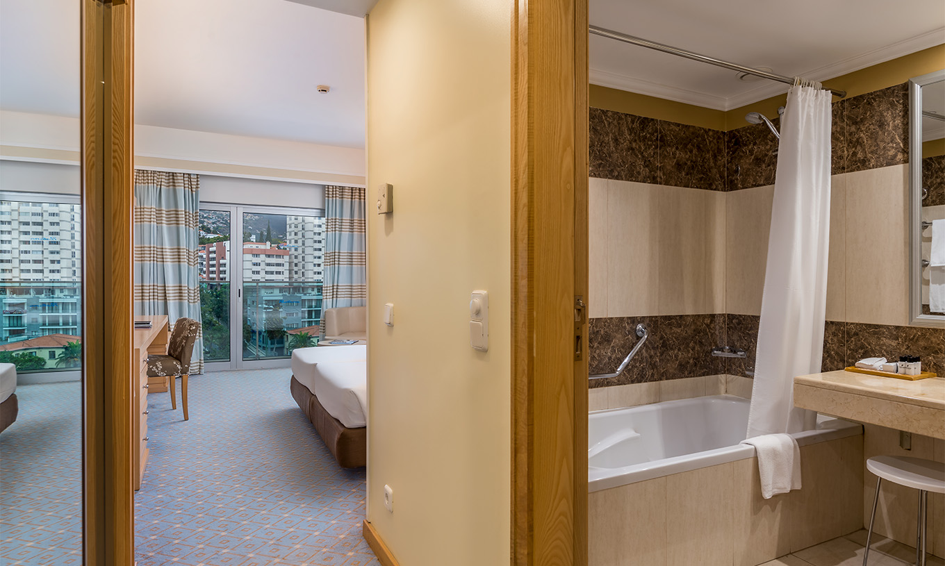 The Twin Classic Room with City View at Pestana Carlton Madeira has a bathroom, large window, and a double bed