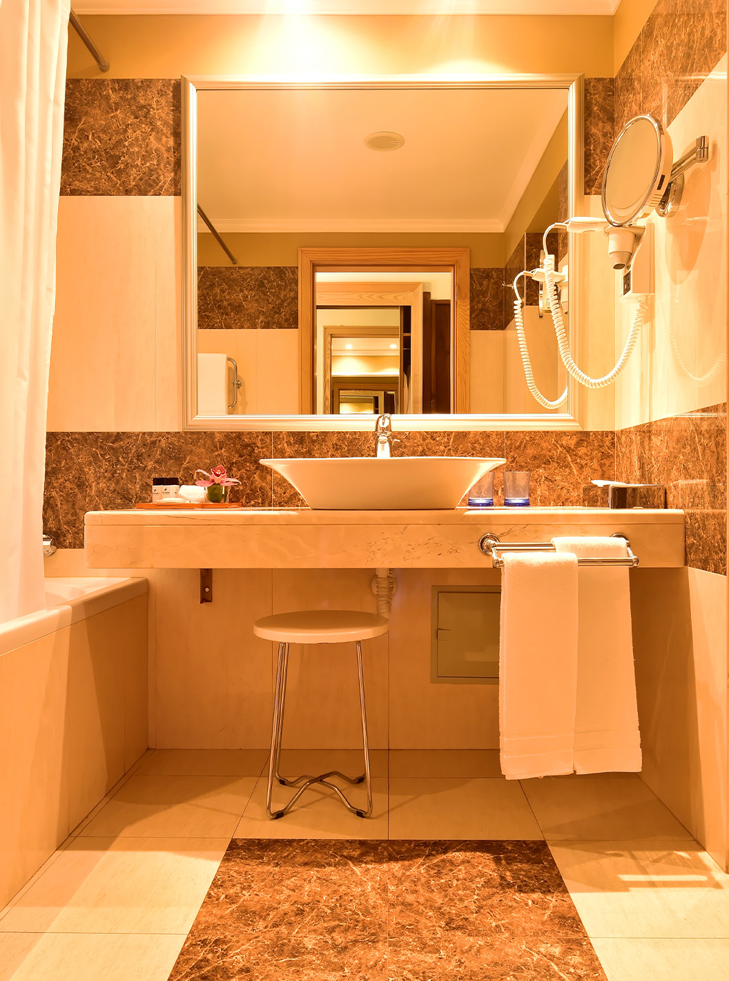 The Classic Double Room with Pool View at Pestana Carlton Madeira has a bathroom with brown tiles and a bathtub