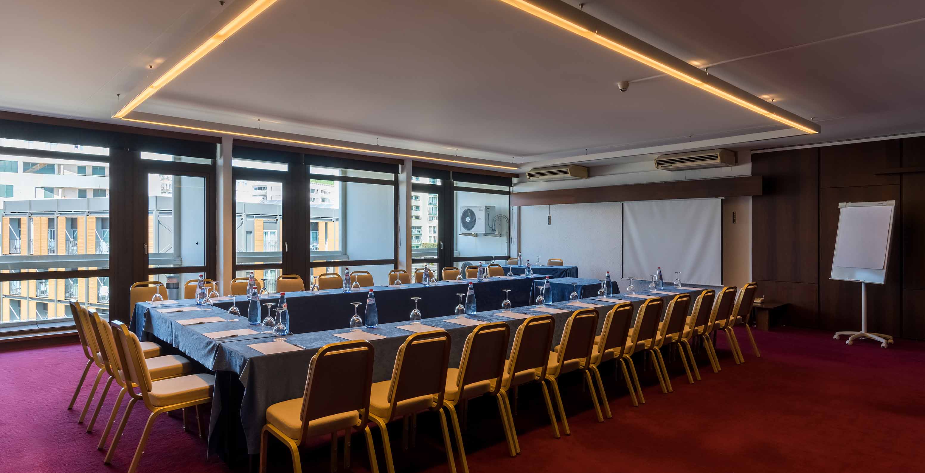 Pestana Casino Park meeting room with a large table surrounded by chairs and a whiteboard in the background