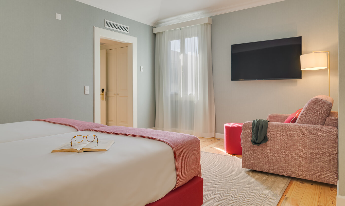 Junior Suite at Pestana Quinta Perestrello has a TV in front of the beds and an armchair against the wall