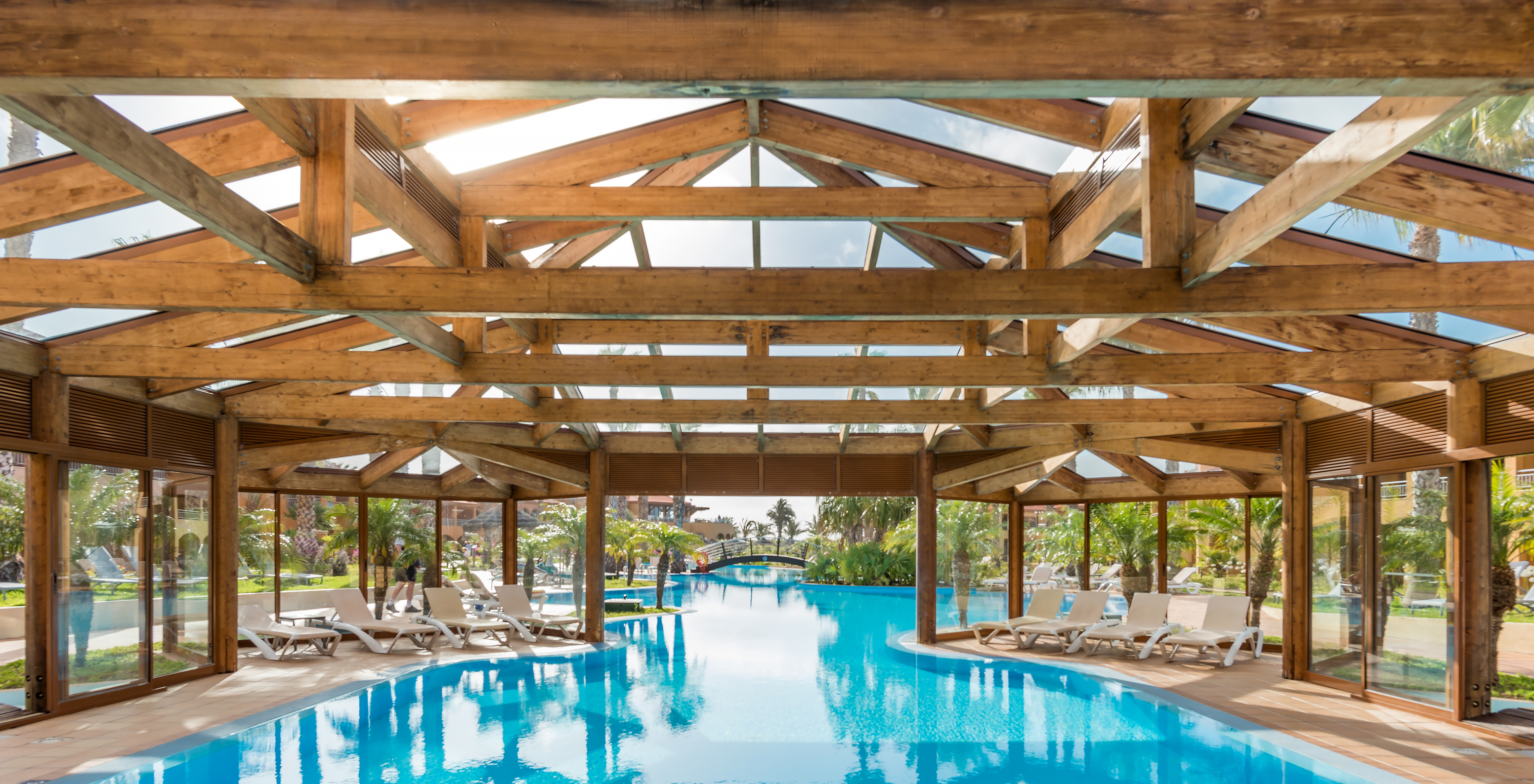 Indoor pool with loungers at Pestana Porto Santo, hotel with all-inclusive and spa in Porto Santo