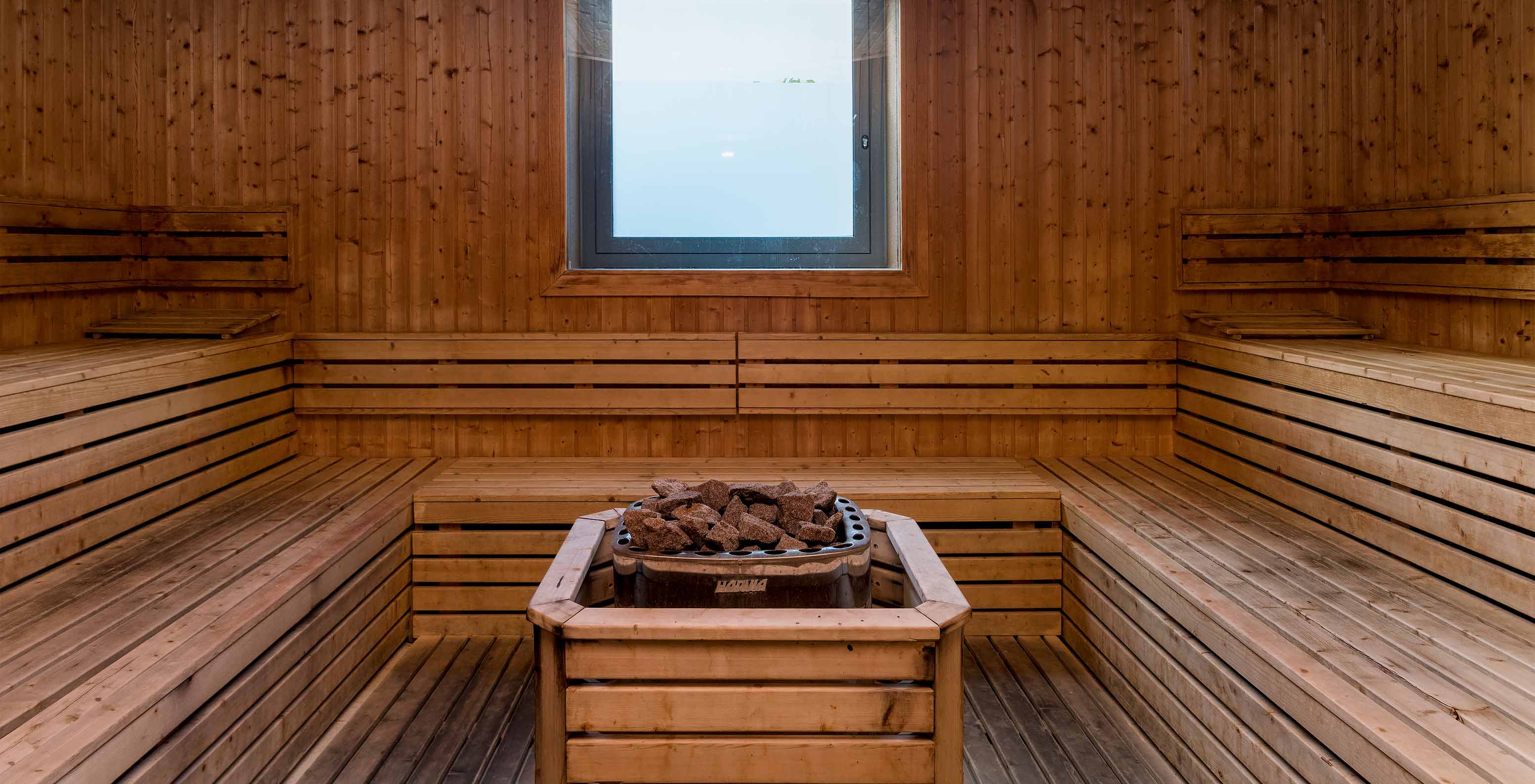 Girl in a swimsuit, smiling and relaxing in the sauna at Pestana Porto Santo, hotel with all-inclusive and spa