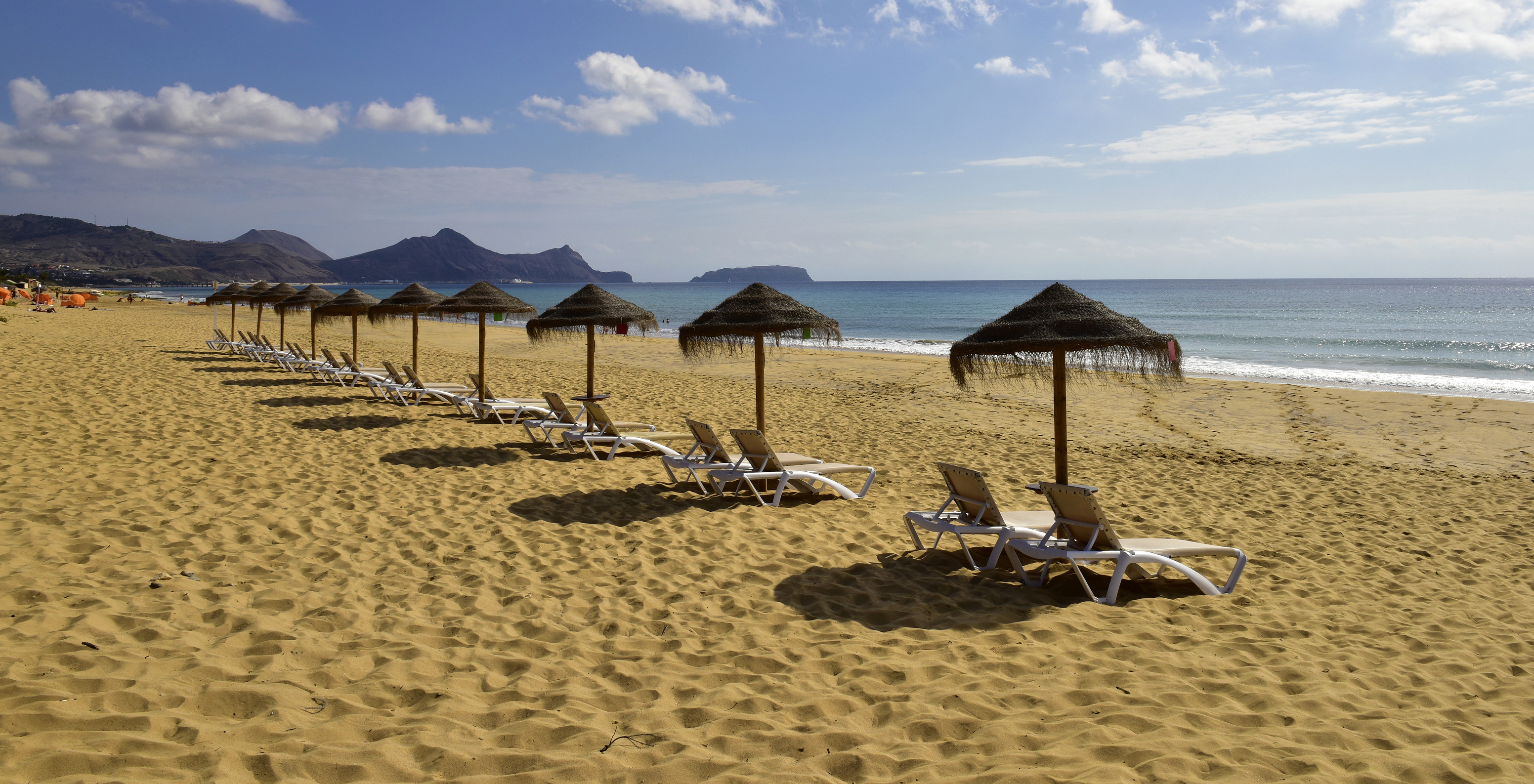 Fine sandy beach, blue sea and mountains in the background, from Pestana Porto Santo, hotel with all-inclusive and spa