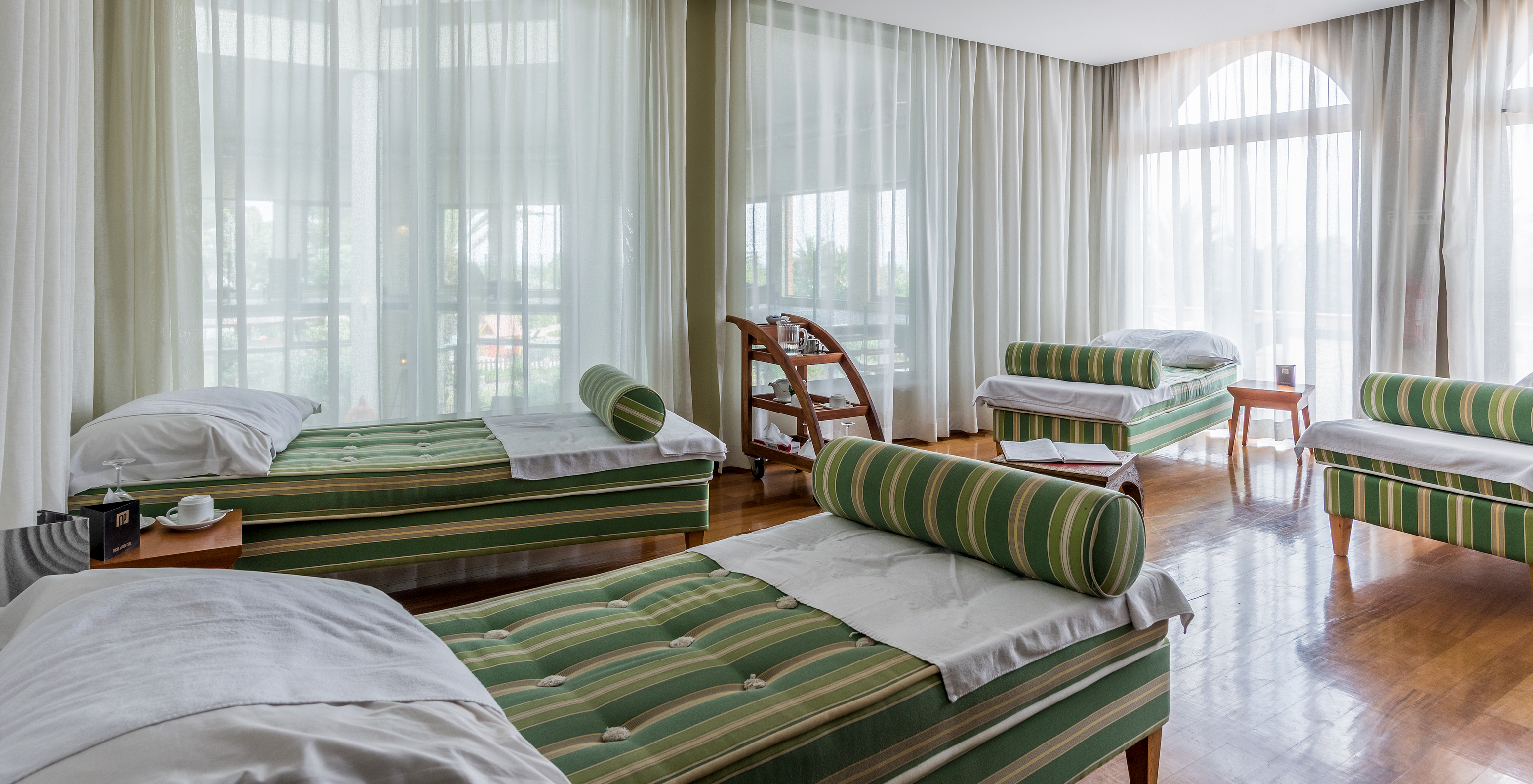 Spa of the all-inclusive hotel in Porto Santo, a room with windows and cushioned treatment tables for client relaxation