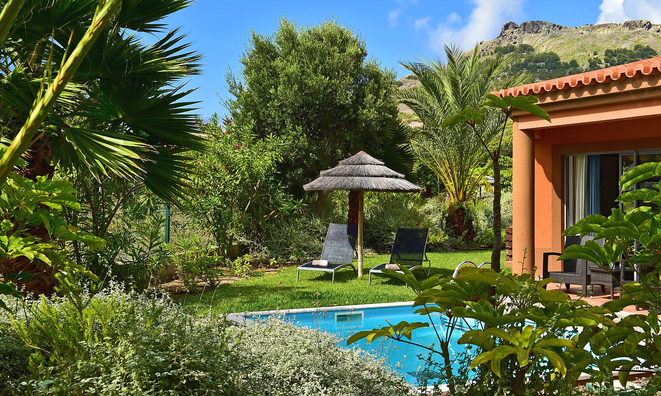 The Pool Villa of Pestana Porto Santo All Inclusive has a private pool, loungers, and a straw hat