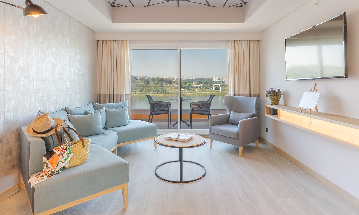The Douro Suite at Pestana Douro Riverside features a living room with a sofa, coffee table, television, and a balcony