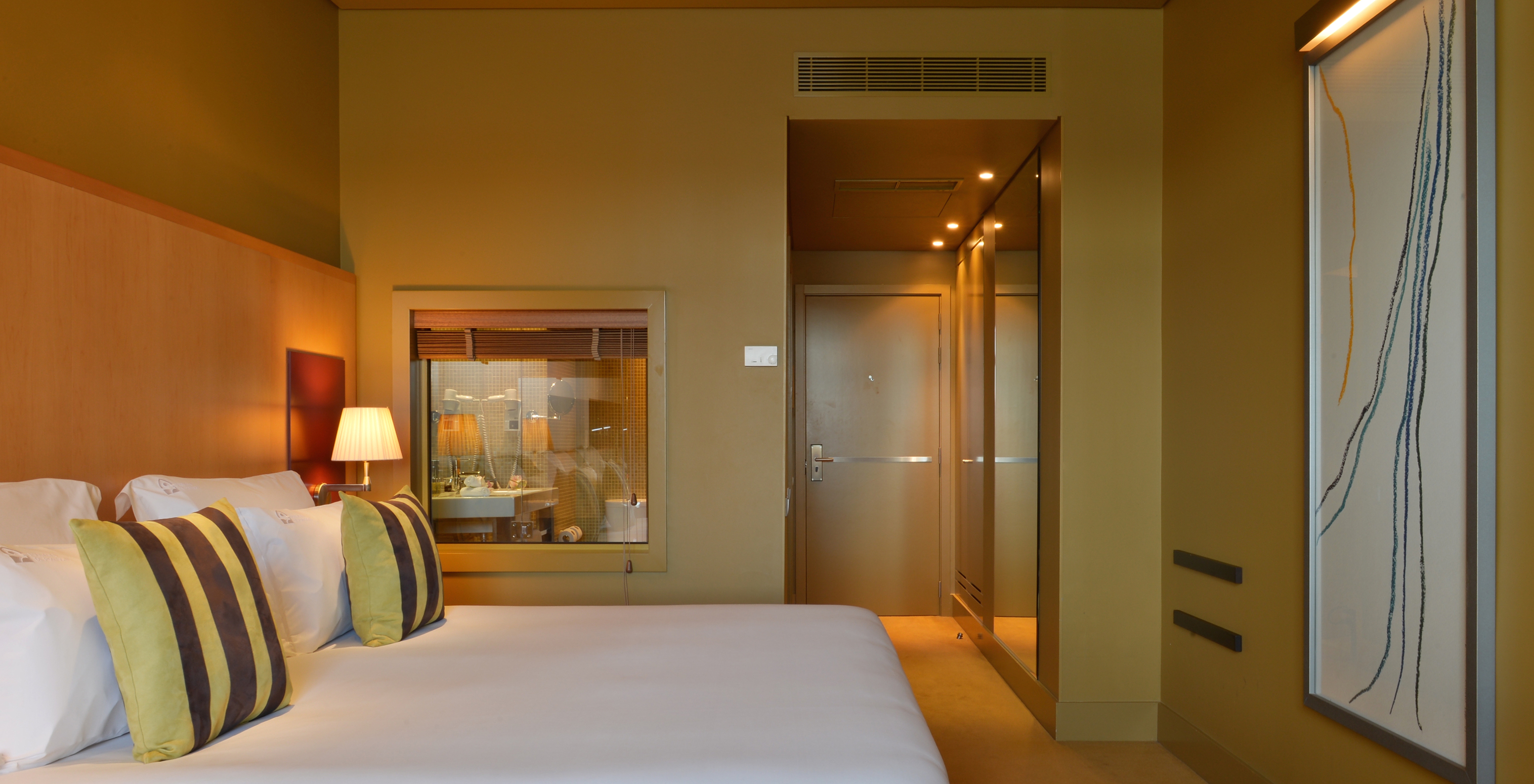 The Executive Superior of Pestana Palácio do Freixo has a hallway at the entrance, a double bed and a large painting in front