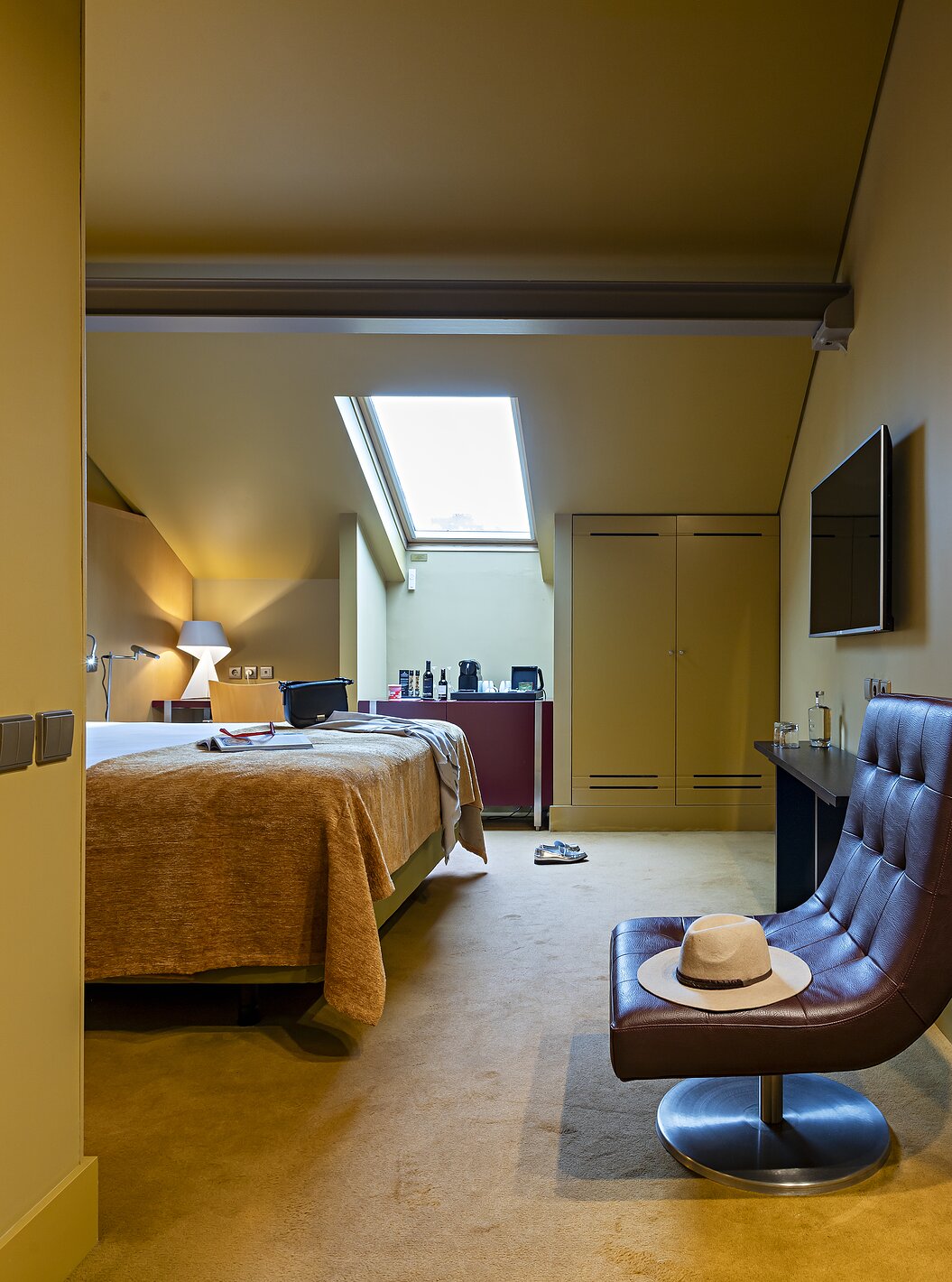 Pestana Palácio do Freixo’s Classic Attic has a double bed, a wardrobe, and a leather armchair