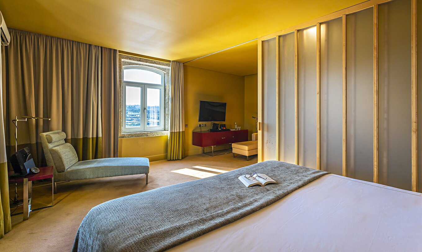 The Standard Suite has a double bed, a chaise-longue, and a window with river view