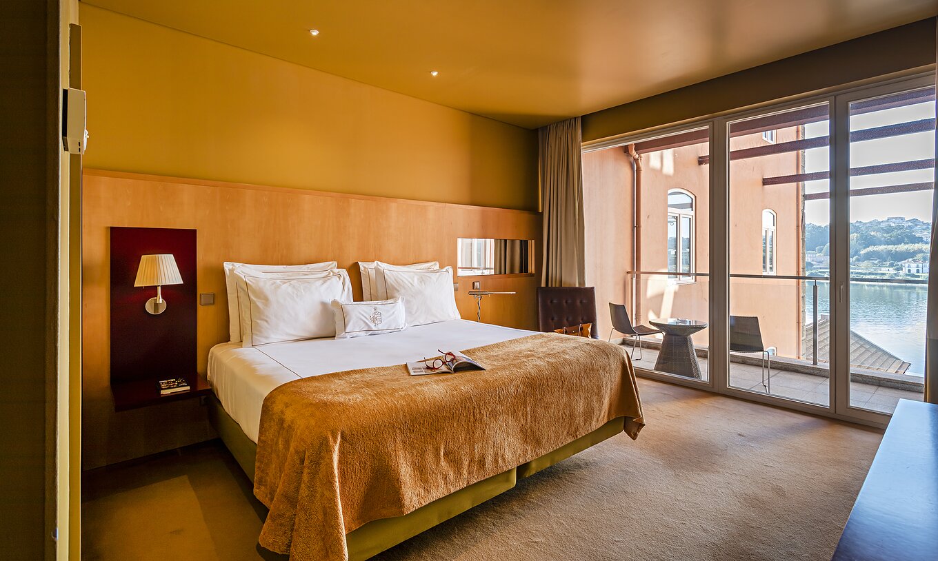 The Suite Balcony has a double bed and a window to the balcony with river view