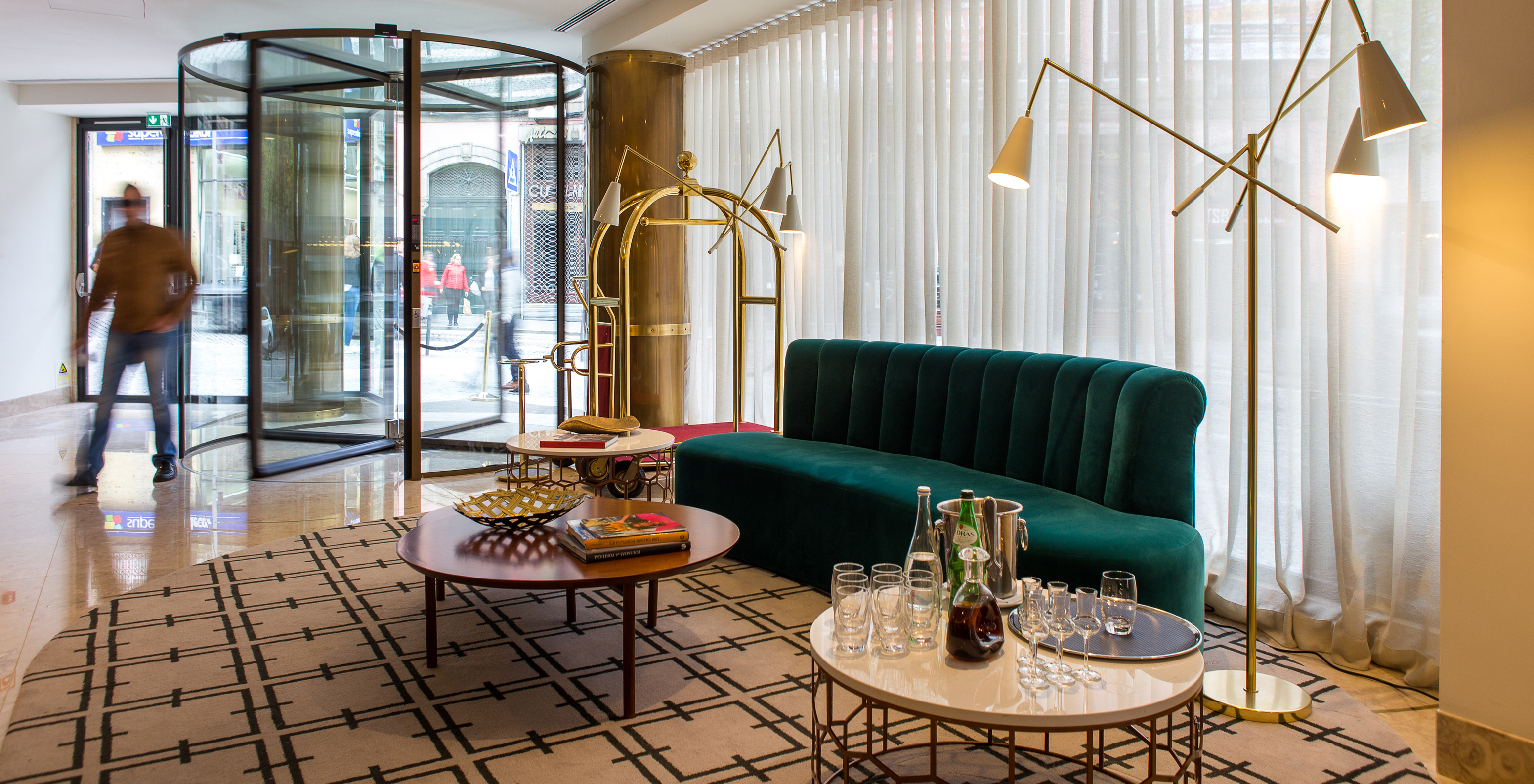 Pestana Porto - A Brasileira, a 5-star hotel in Porto, has a lobby with a sofa for guests to relax