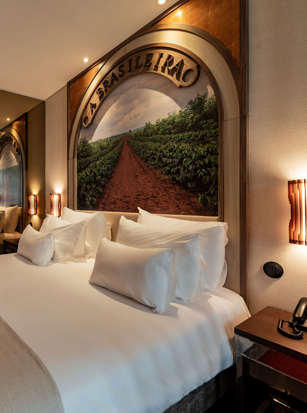 Junior Suite Reserve at Pestana Porto - A Brasileira featuring a king bed, warm lighting and mural wall