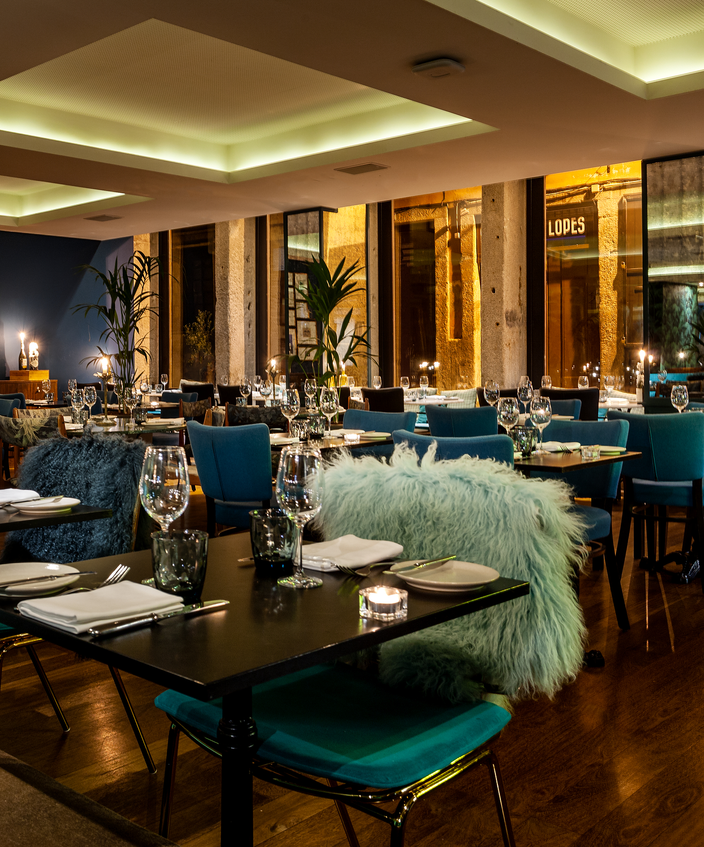 Restaurant tables set with blue chairs at Pestana Vintage Porto, a hotel in Praça da Ribeira, Porto