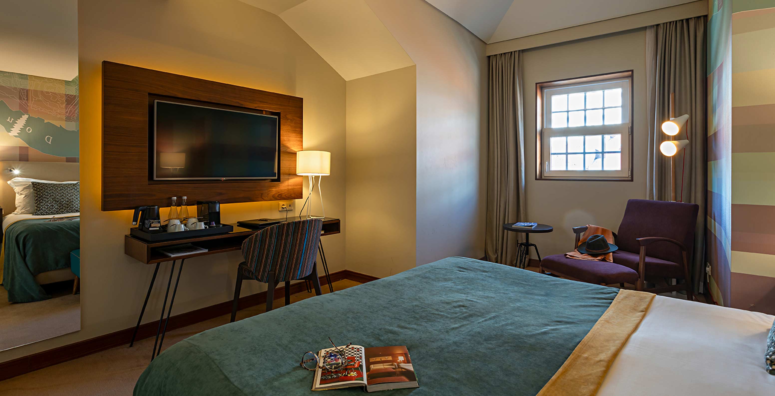The Classic at Pestana Vintage Porto has a television in front of the bed, a window with a view and a mirror