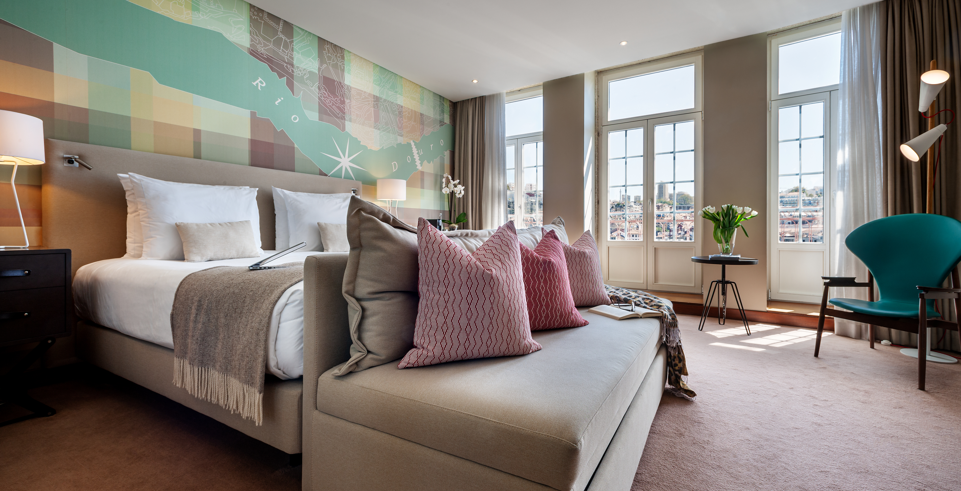 The Vintage Grand View Balcony room at Pestana Vintage Porto has a double bed with a sofa, three windows and an armchair