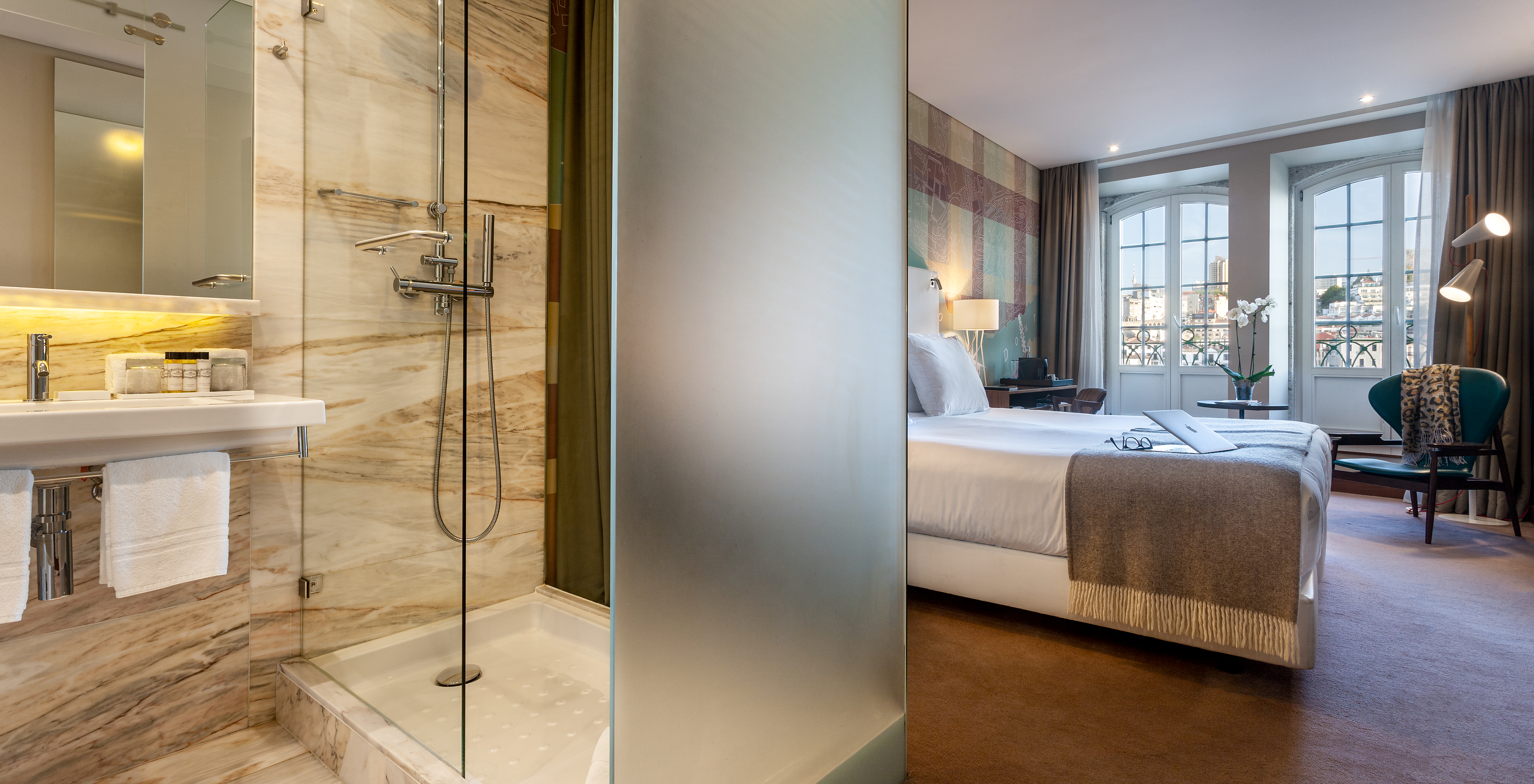 The Vintage River View Balcony room at Pestana Vintage Porto has a bathroom with shower and view of the double bed