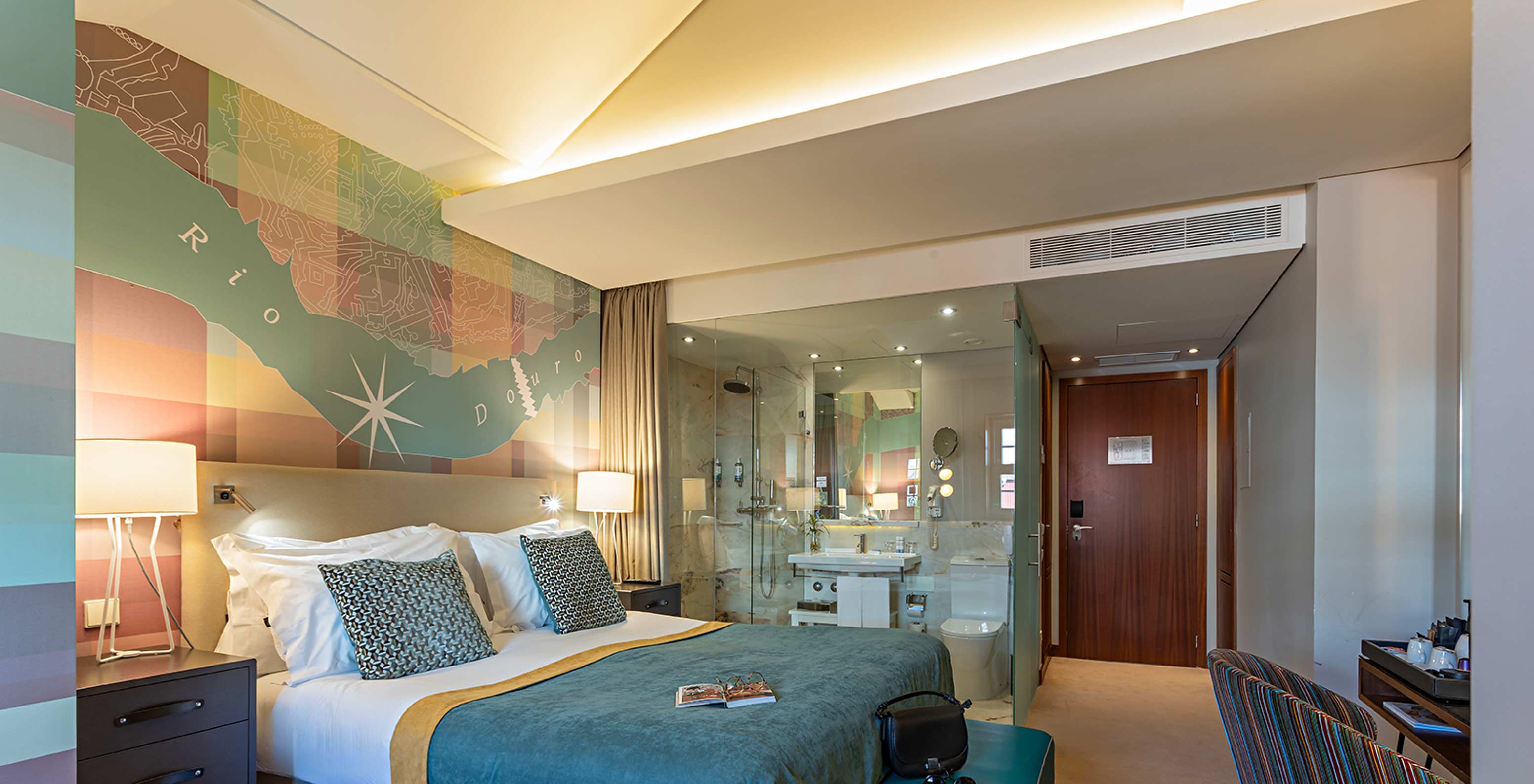 The Classic room at Pestana Vintage Porto has a double bed, a desk and wallpaper with images
