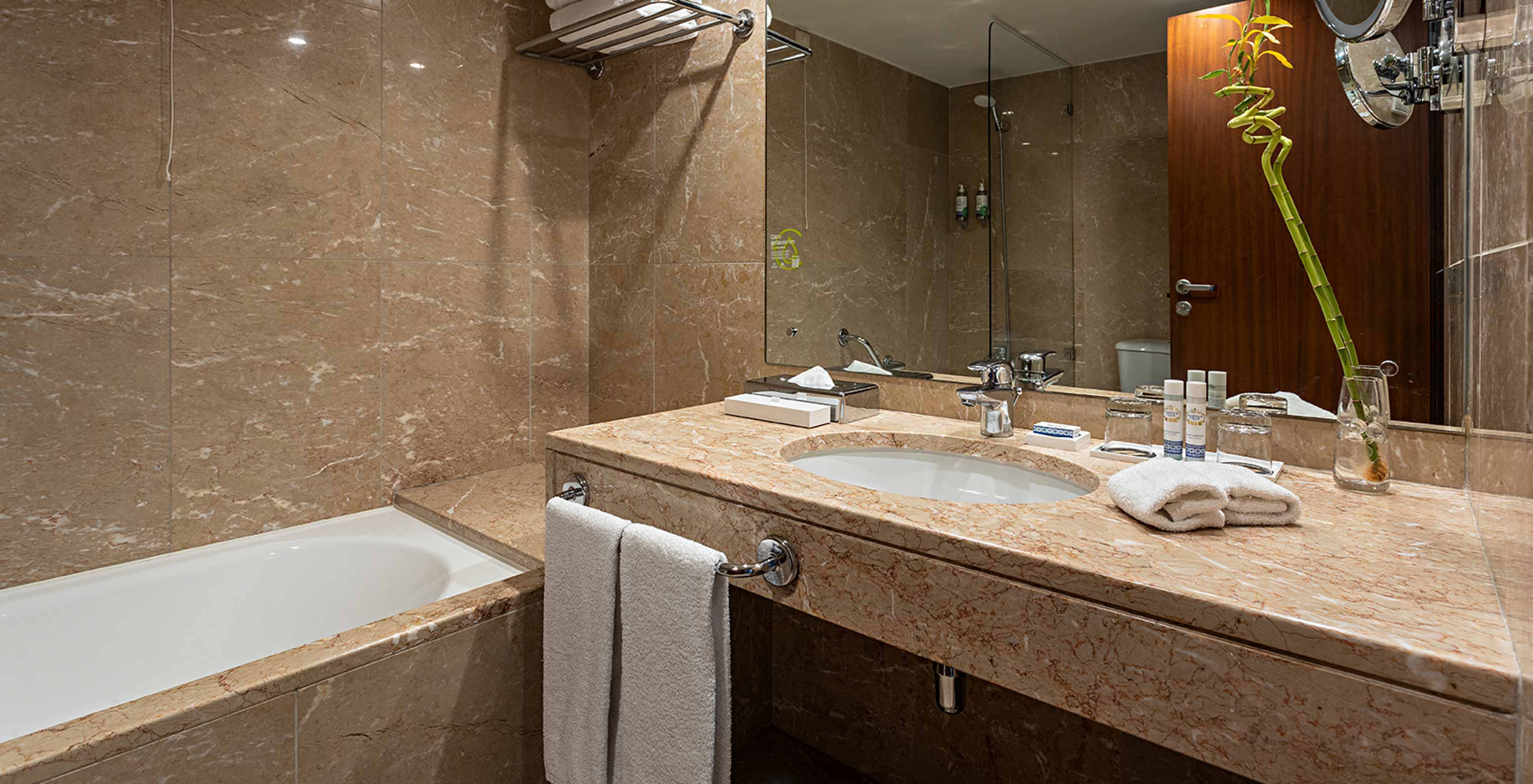 The Vintage River View room at Pestana Vintage Porto has a bathroom with large mirror, sink, toilet and shower